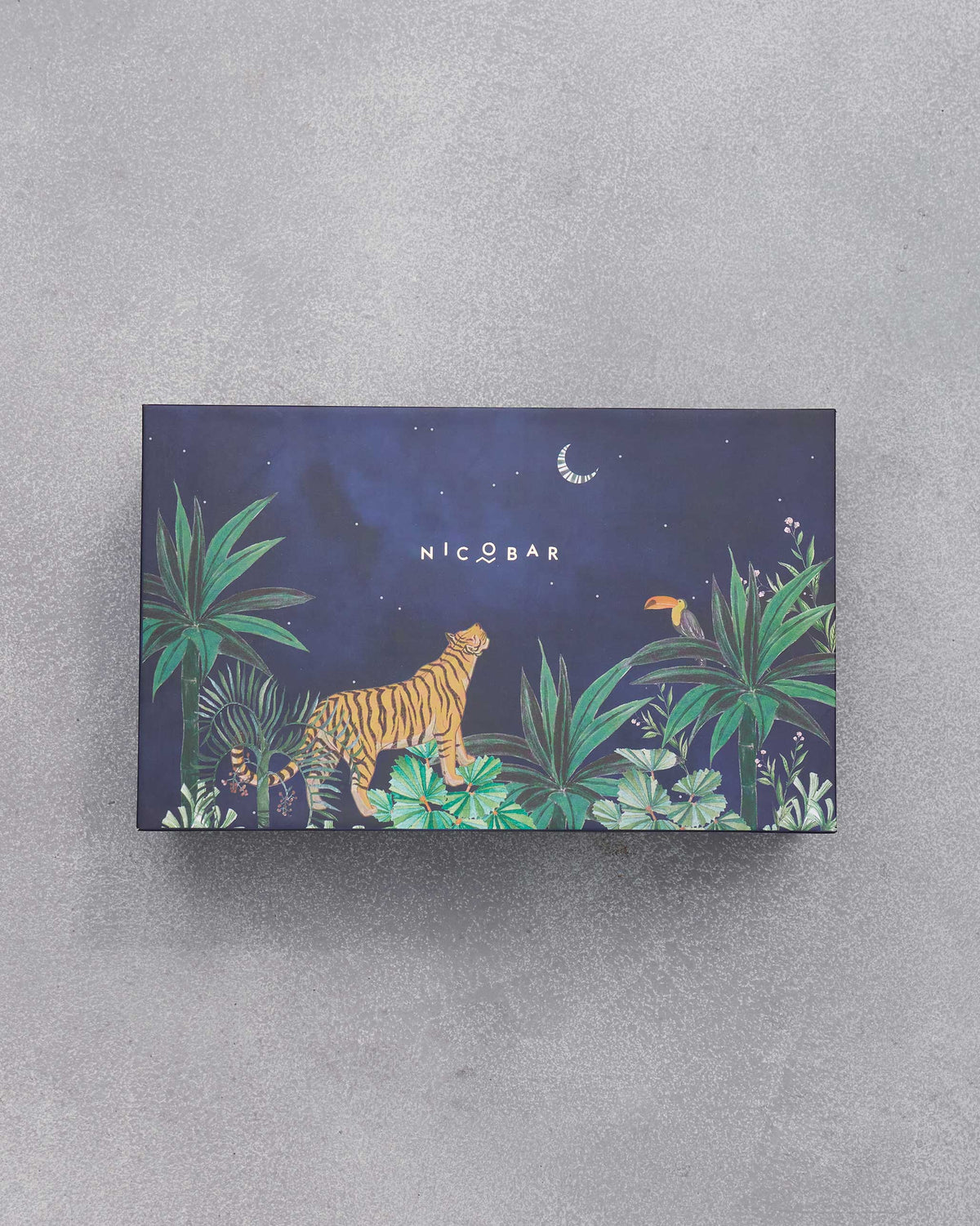 Closed Azraq gift box with a tiger and toucan jungle illustration.