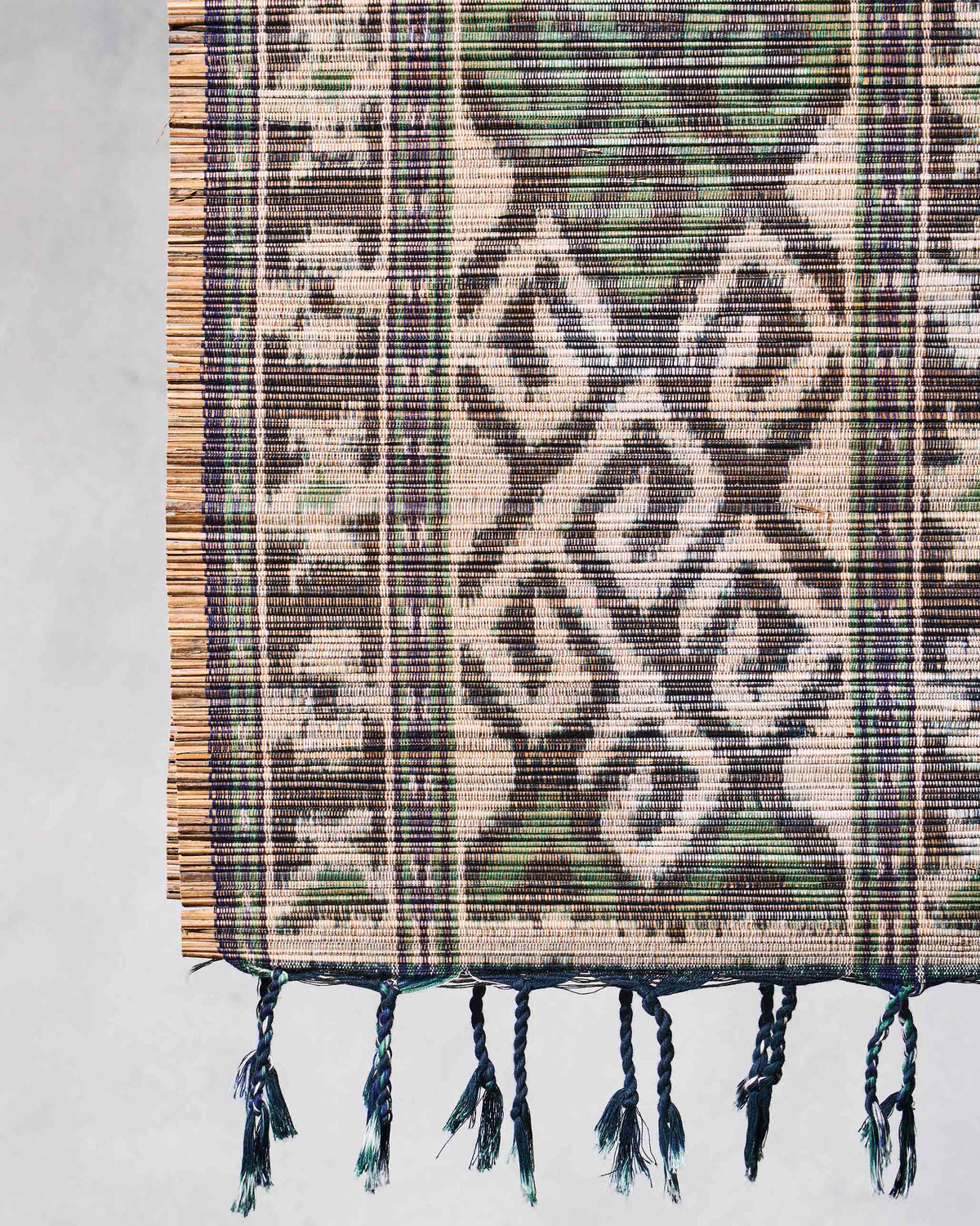 Close-up of Sitara Ikat Runner end showing diamond motifs and tassels.