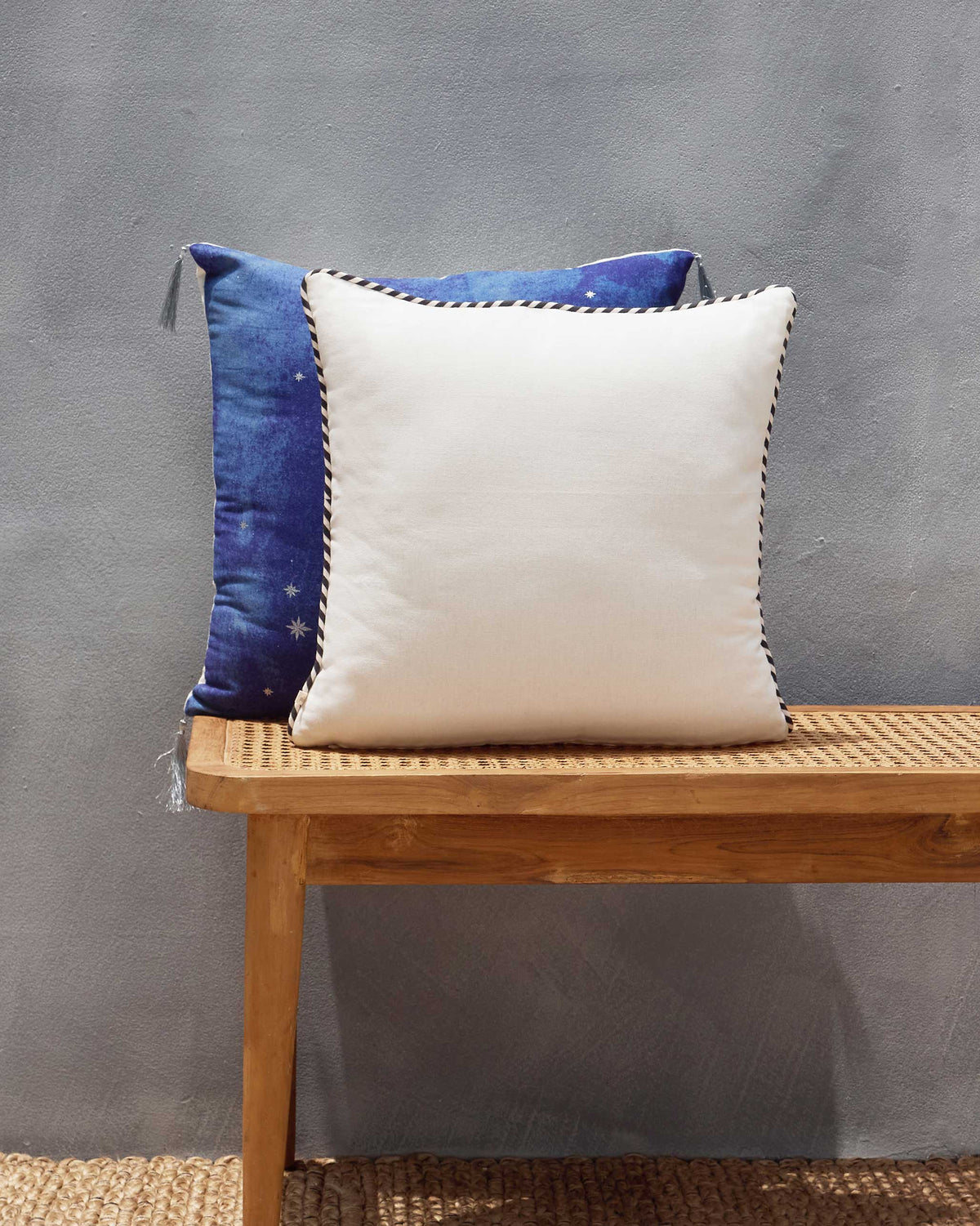 Back of the Asfar Cushion Cover, plain cream with black and white piping.