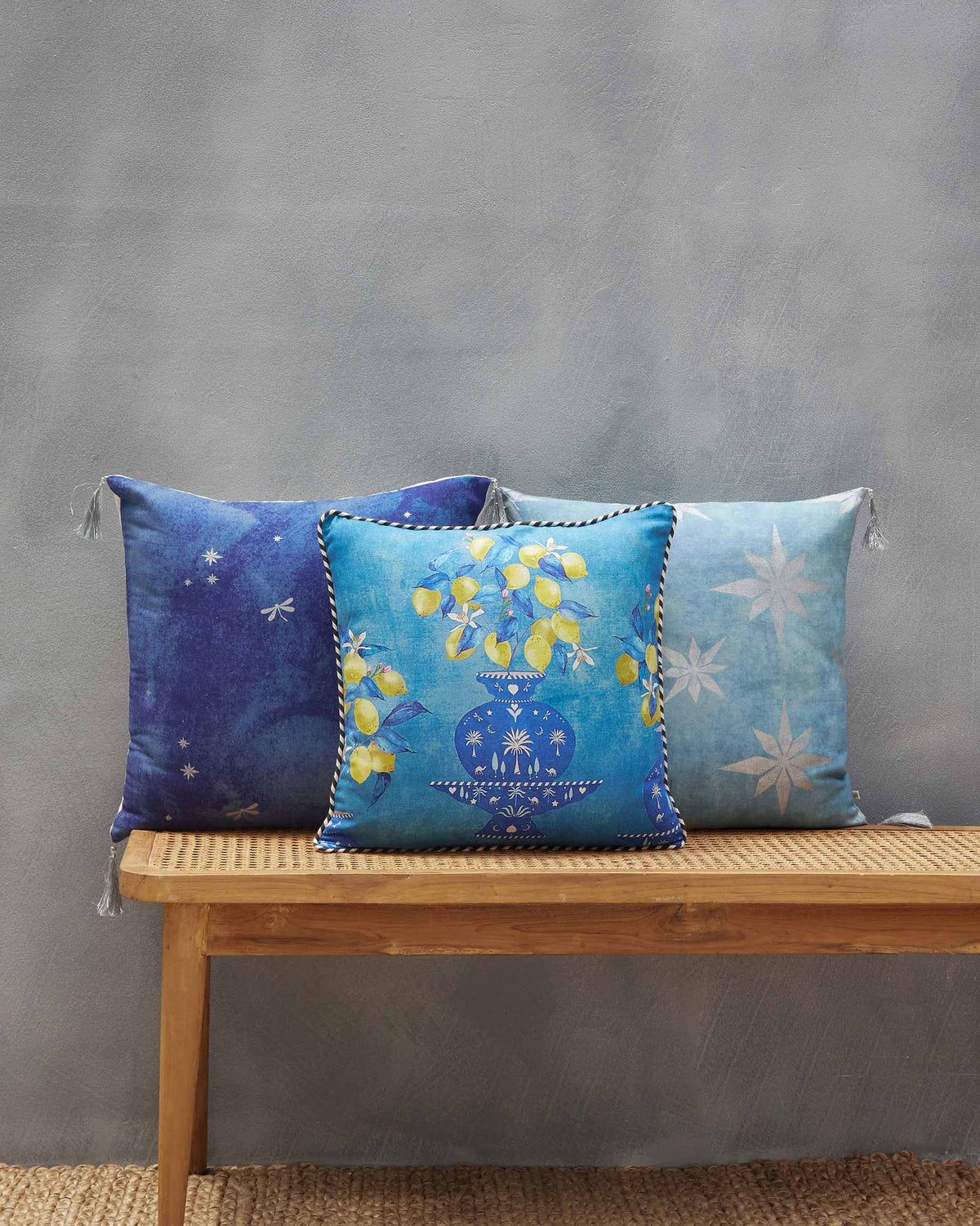 Asfar Cushion Cover with the lemon print at the front, between star-print cushions.