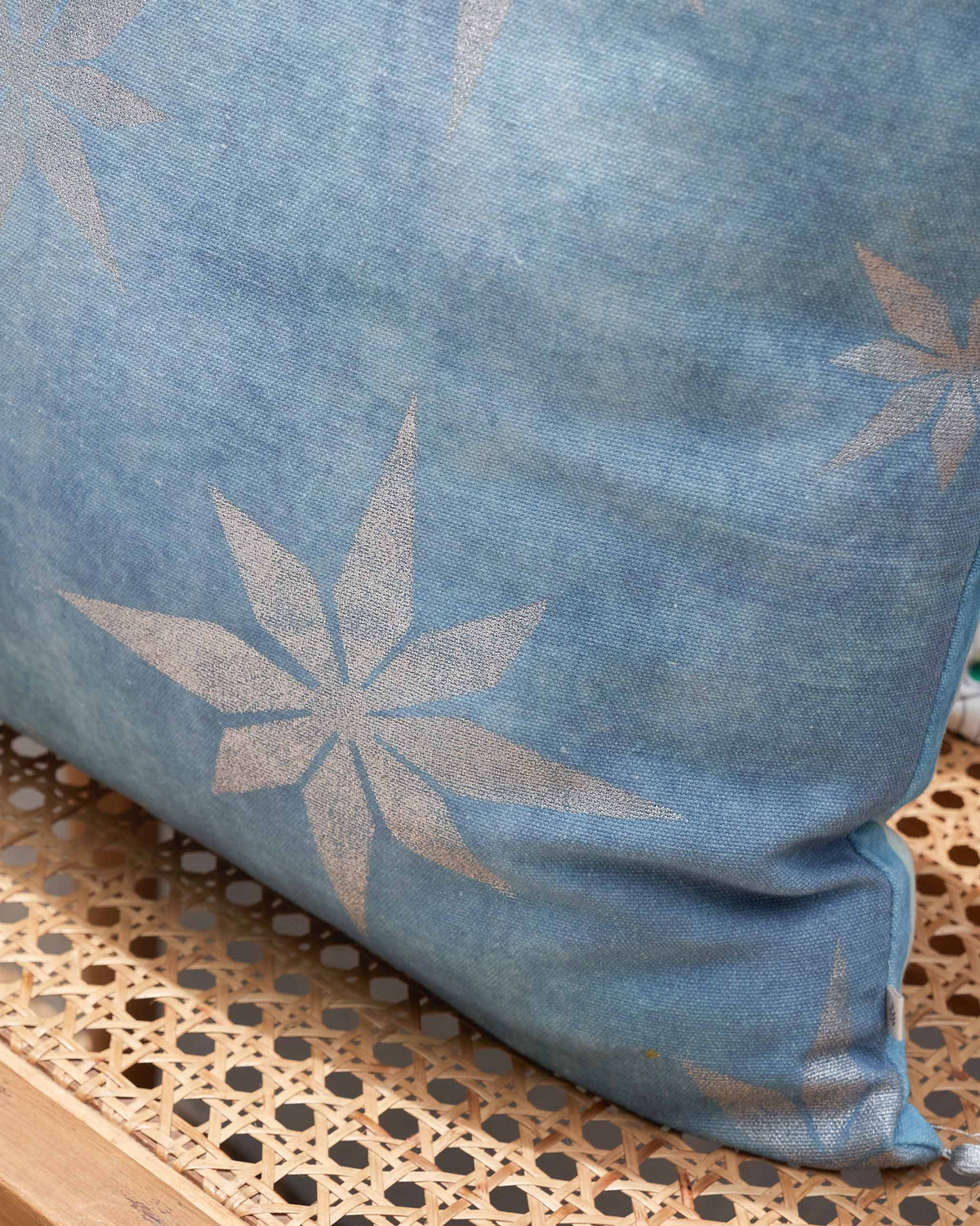 Close-up of Azraq Tile Cushion Cover showing a pale star motif on blue fabric.