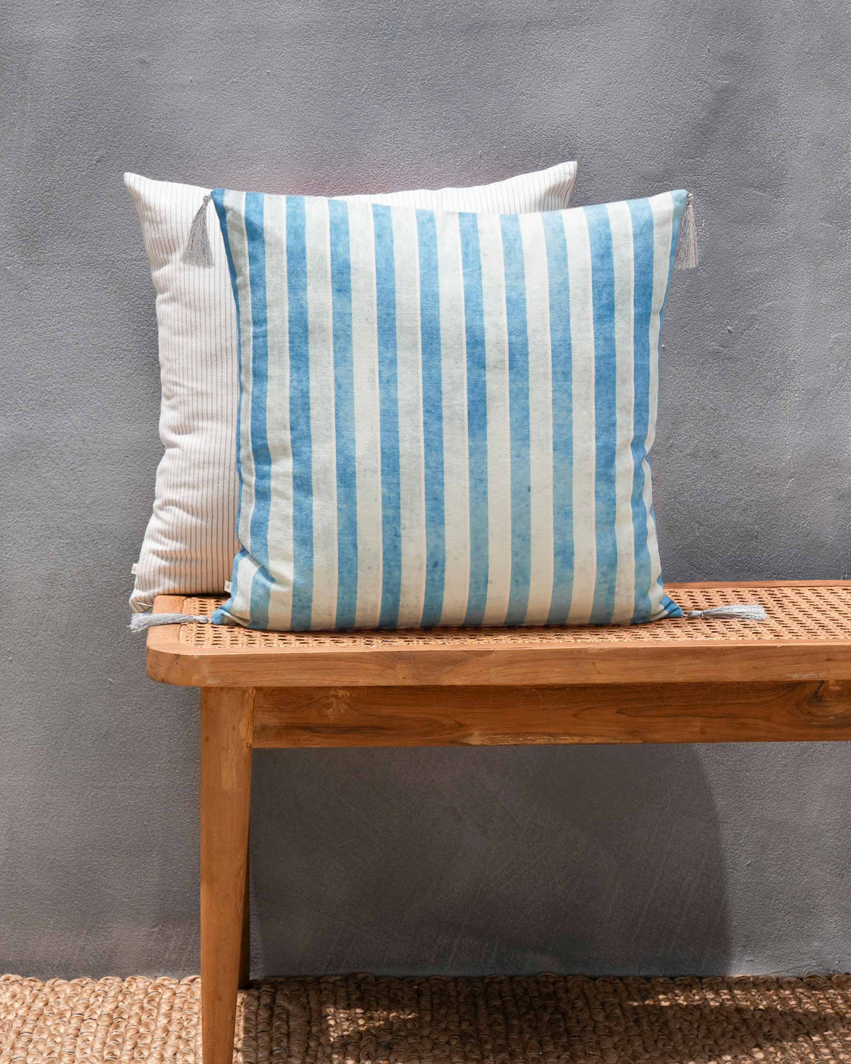Azraq Tile Cushion Cover in blue and white vertical stripes.