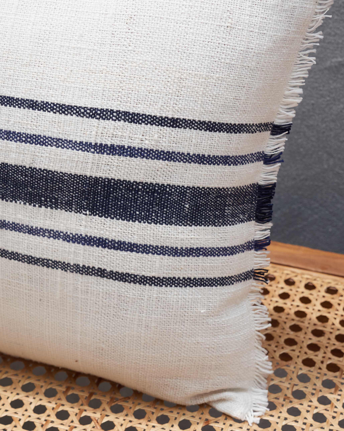 Close-up of the Sahara French Stripe Lumbar showing navy stripes and a frayed edge.