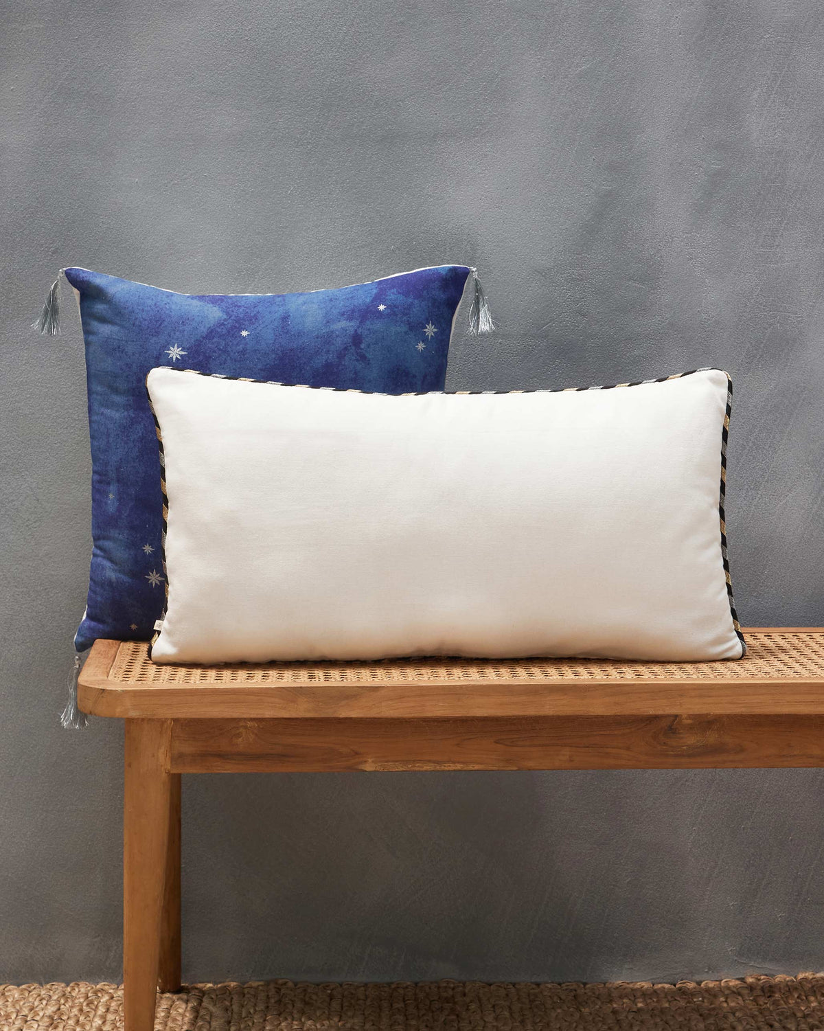 Back of the pineapple trio lumbar cushion cover in plain cream with a piped edge.