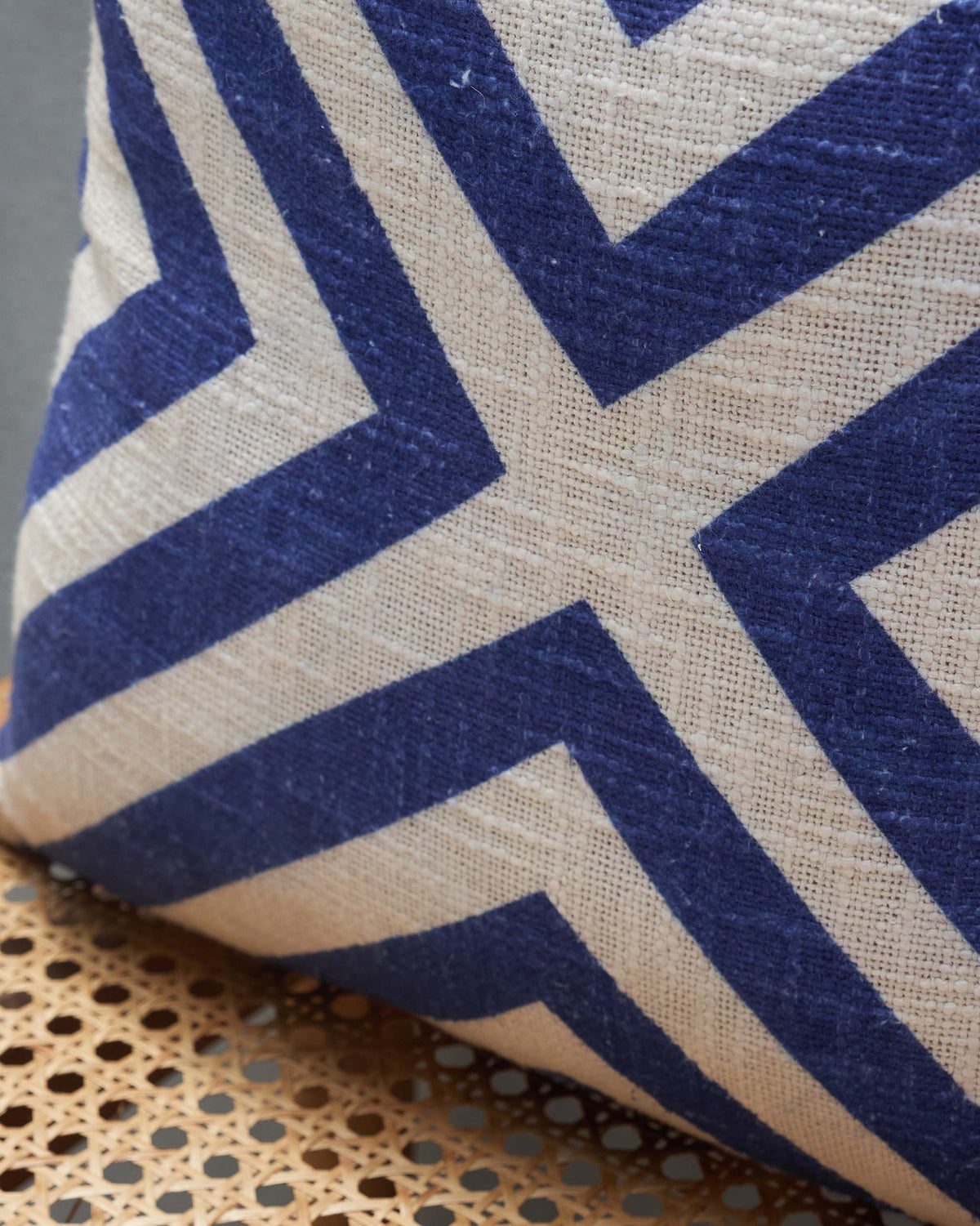 Close-up of Nizara Herring Cushion Cover - Indigo showing its blue and cream stripes.