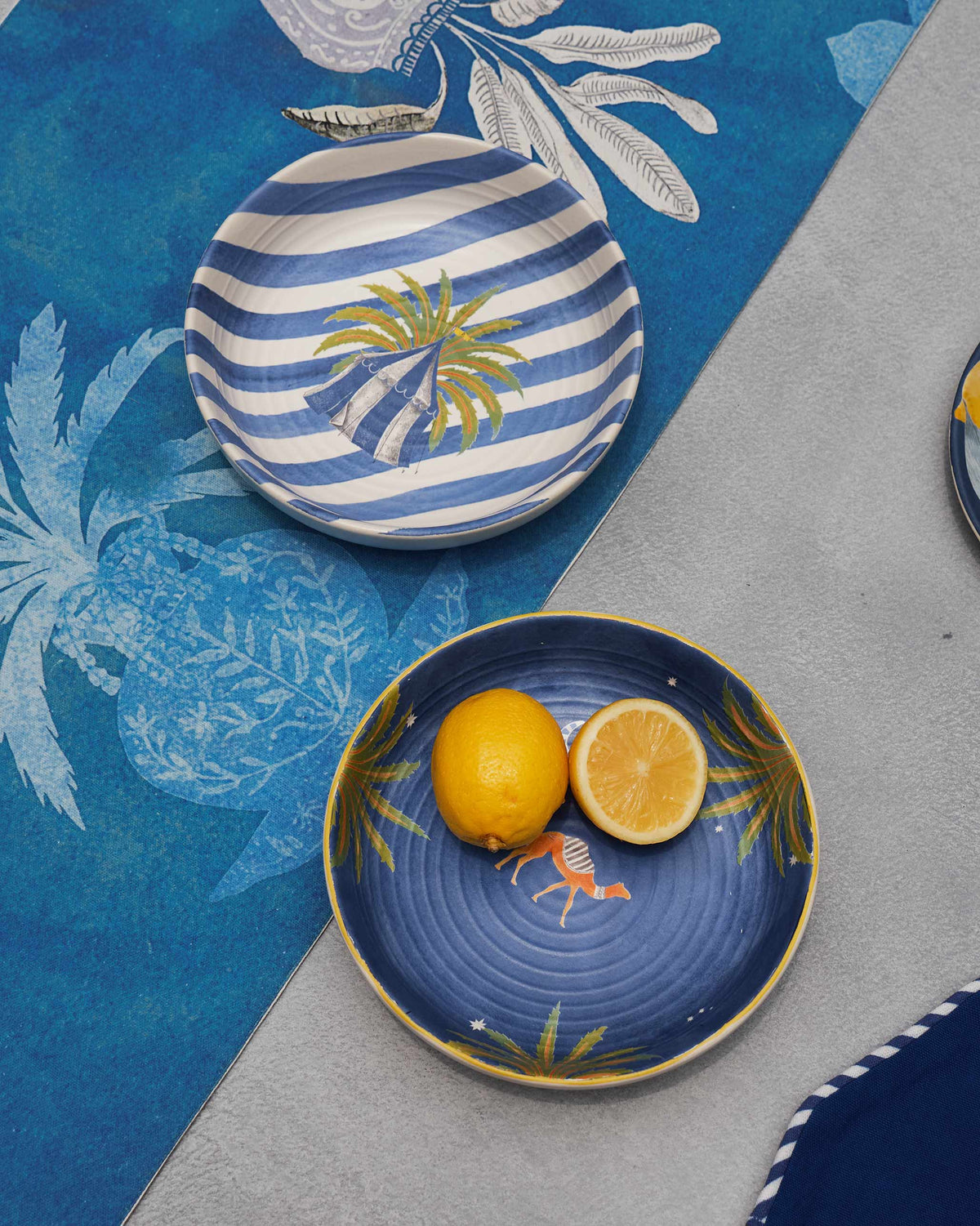 Azraq table runner styled on a table with blue plates and a lemon.