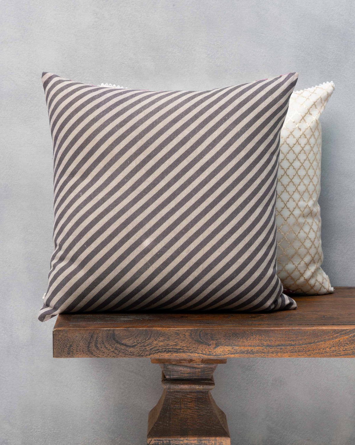 Chambray Arch Cushion in grey and cream diagonal stripes.