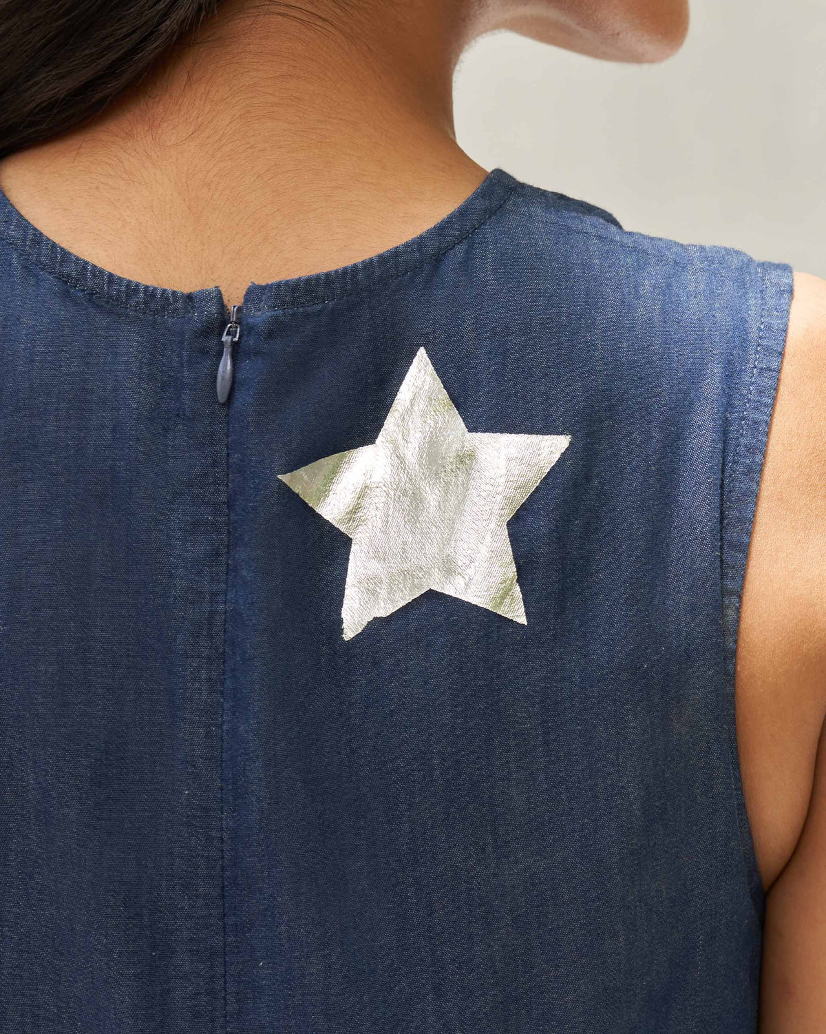 Close-up of Front Knot Jumpsuit showing a silver star print on the back.