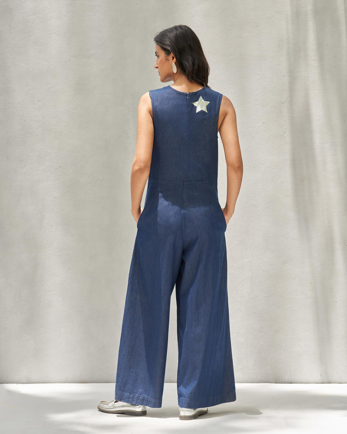 Back of Front Knot Jumpsuit worn by a person, with a silver star on the upper back.