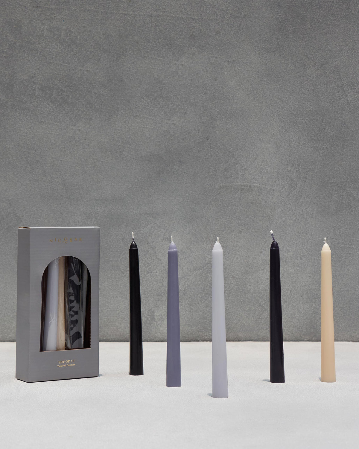 Twilight Tapered Candles - Set of 10 in black, grey and cream, shown unlit.