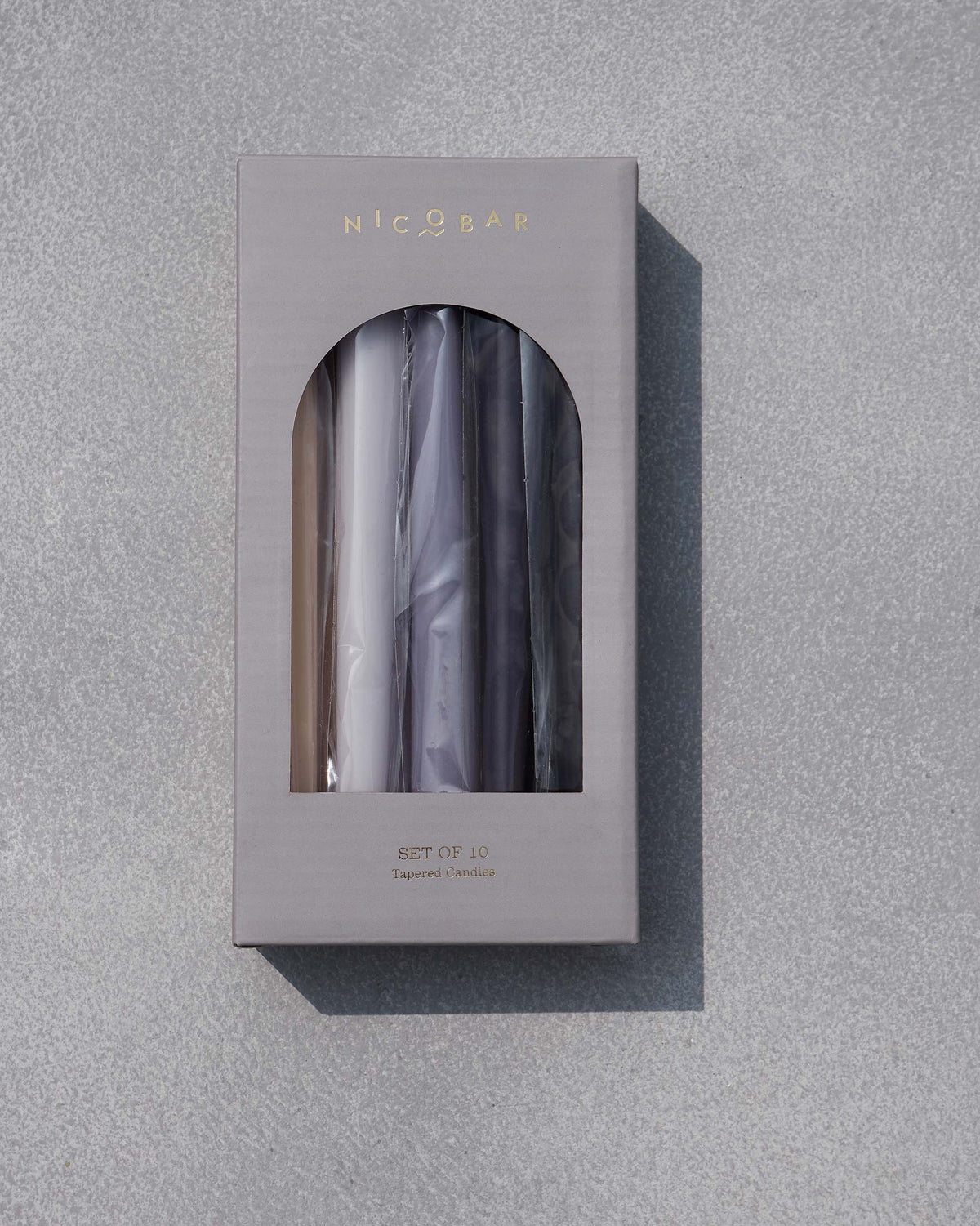 Twilight Tapered Candles - Set of 10 in a closed grey gift box with an arched window.