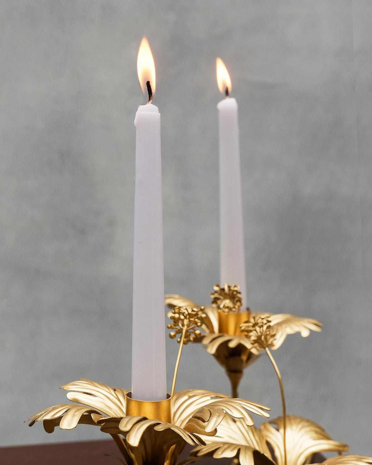 Close-up of two lit Twilight Tapered Candles showing their flames.