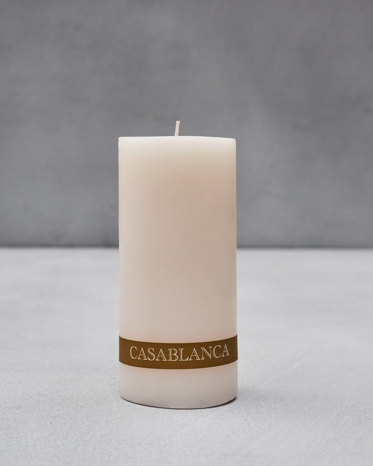 Unlit Casablanca Pillar Candle with a gold CASABLANCA label.