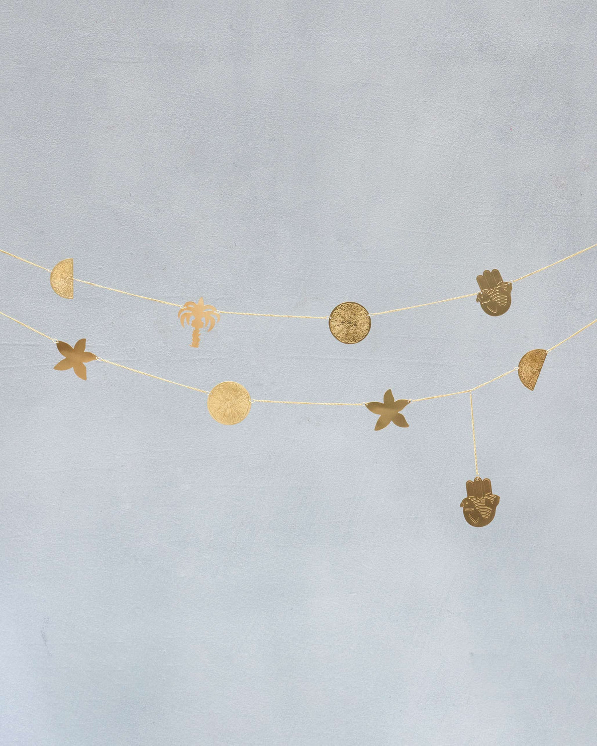 Pair of gold Desert Star toran strands with desert and palm charms.