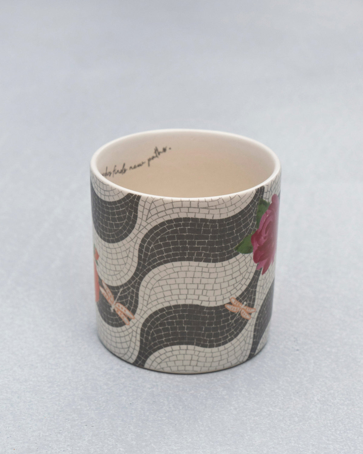Looking into a Mosaic Bloom straight mug with mosaic exterior and cursive rim text.