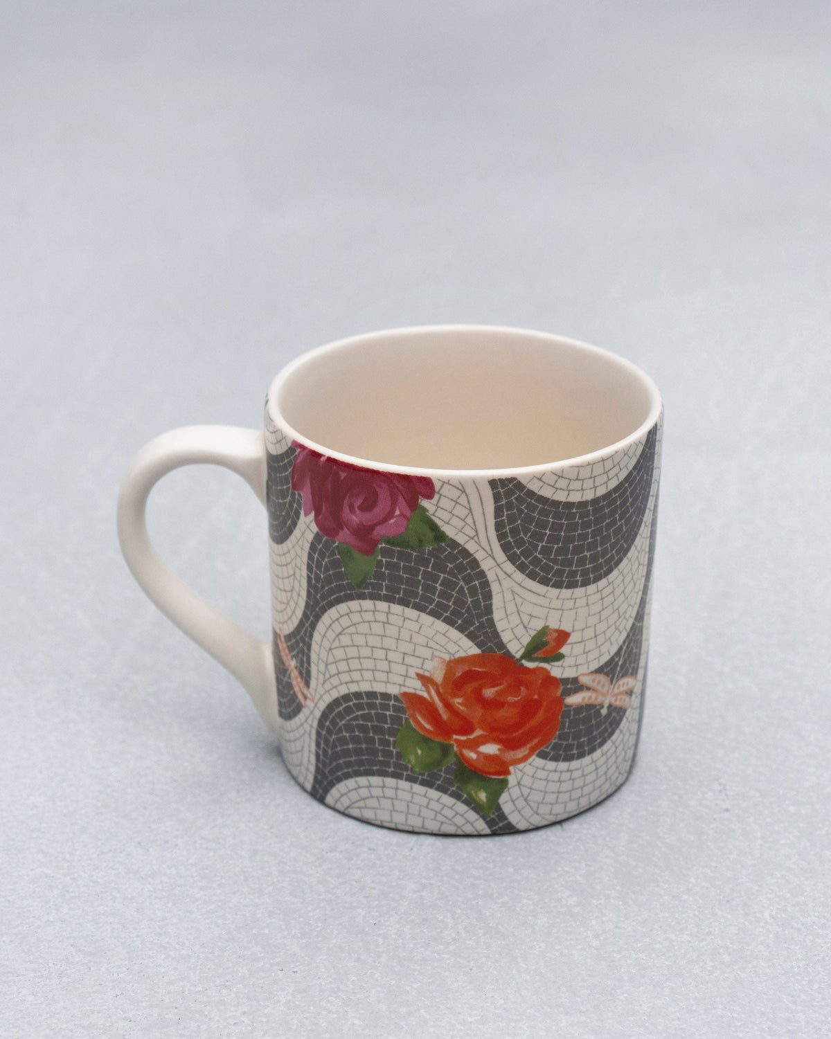 Mosaic Bloom straight mug covered in grey mosaic waves with pink and orange roses.