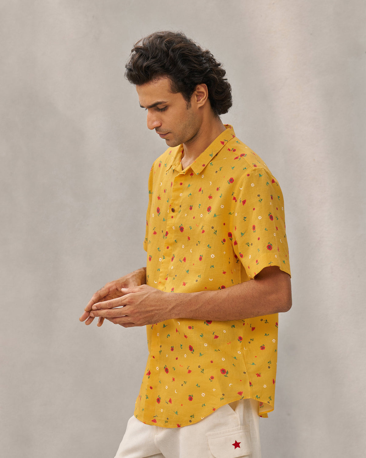 Side view of the Riverline Shirt in yellow, worn by a person.