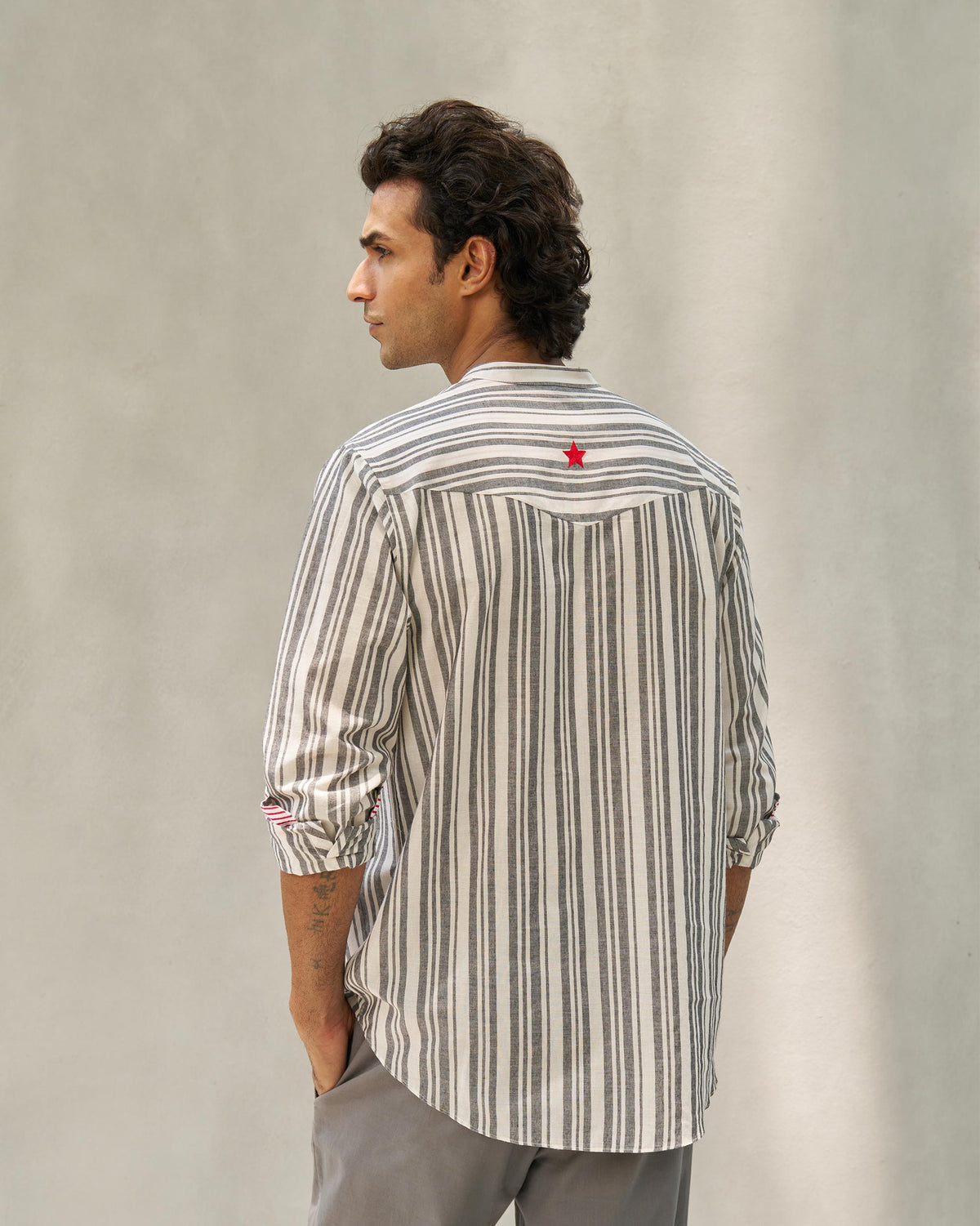 Back of an ivory and grey Pondicherry Shirt with a red star on the yoke.