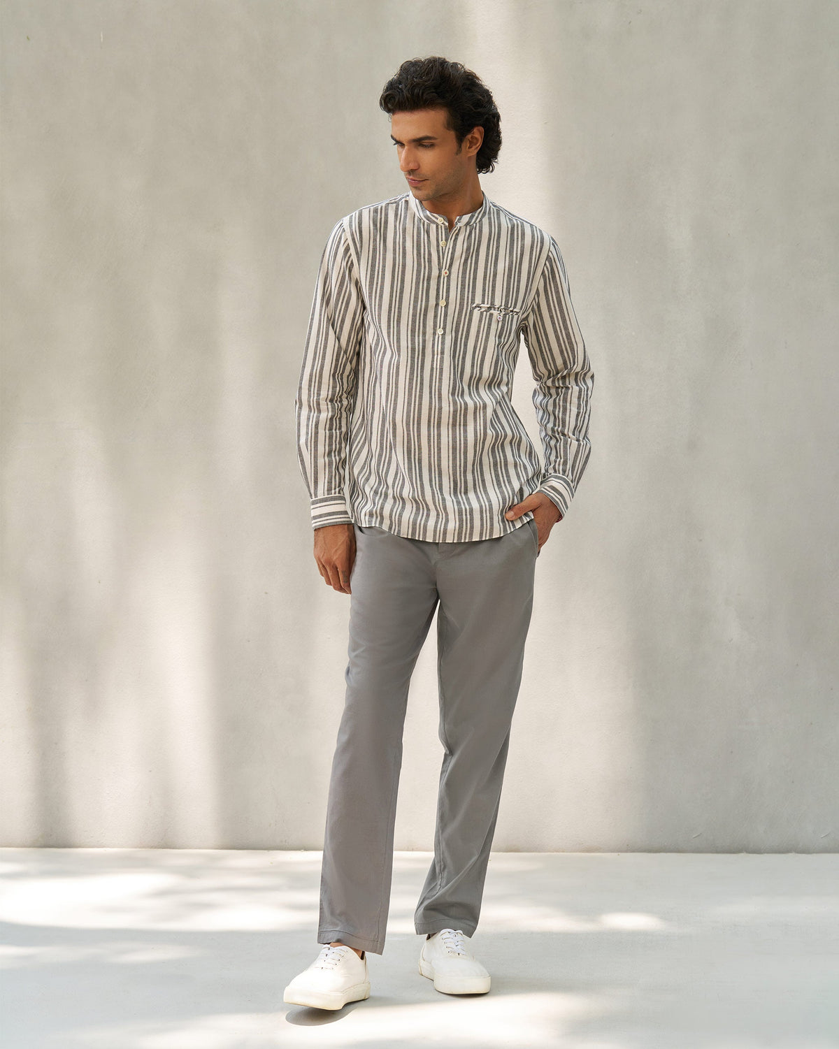 Person wearing a full-length ivory and grey Pondicherry Shirt.