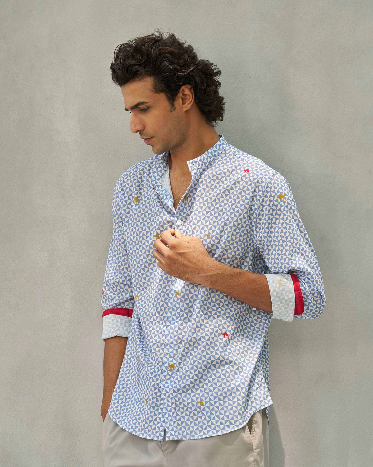 Person wearing a blue and white Angtak Shirt with red-trimmed cuffs.