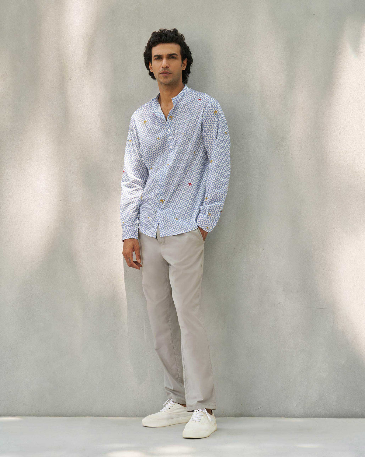 Full-length view of a blue and white Angtak Shirt worn by a person.