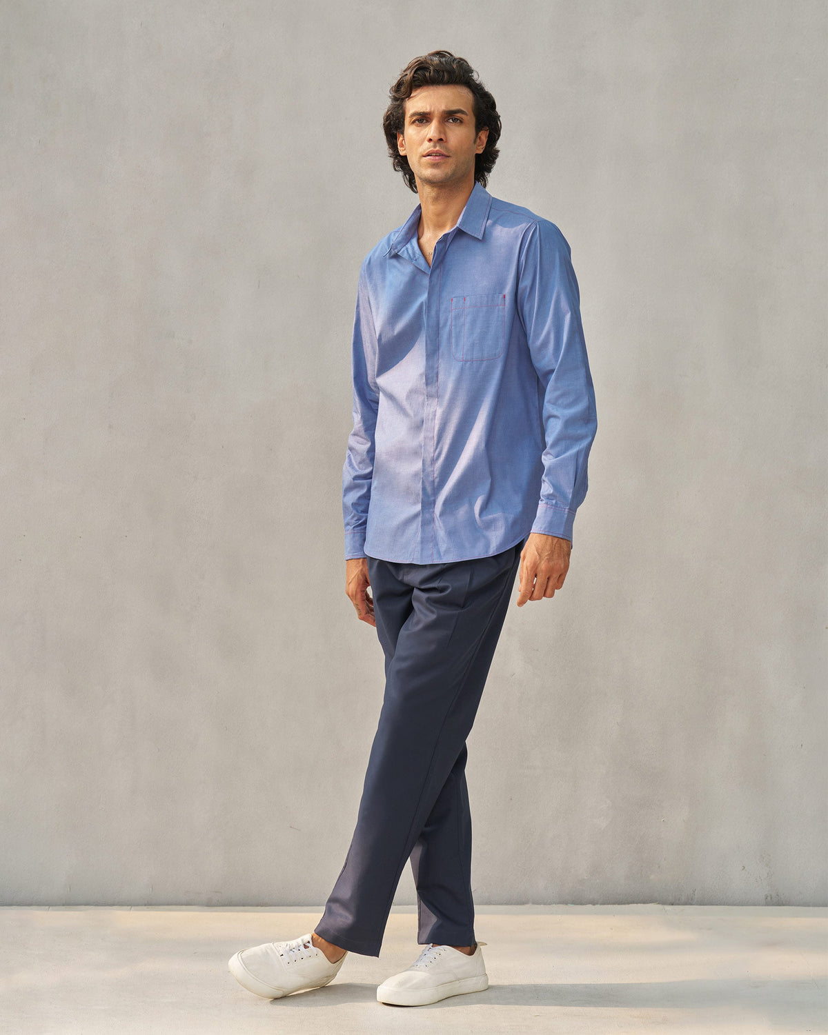 Person wearing navy Forty Trousers, full-length view.
