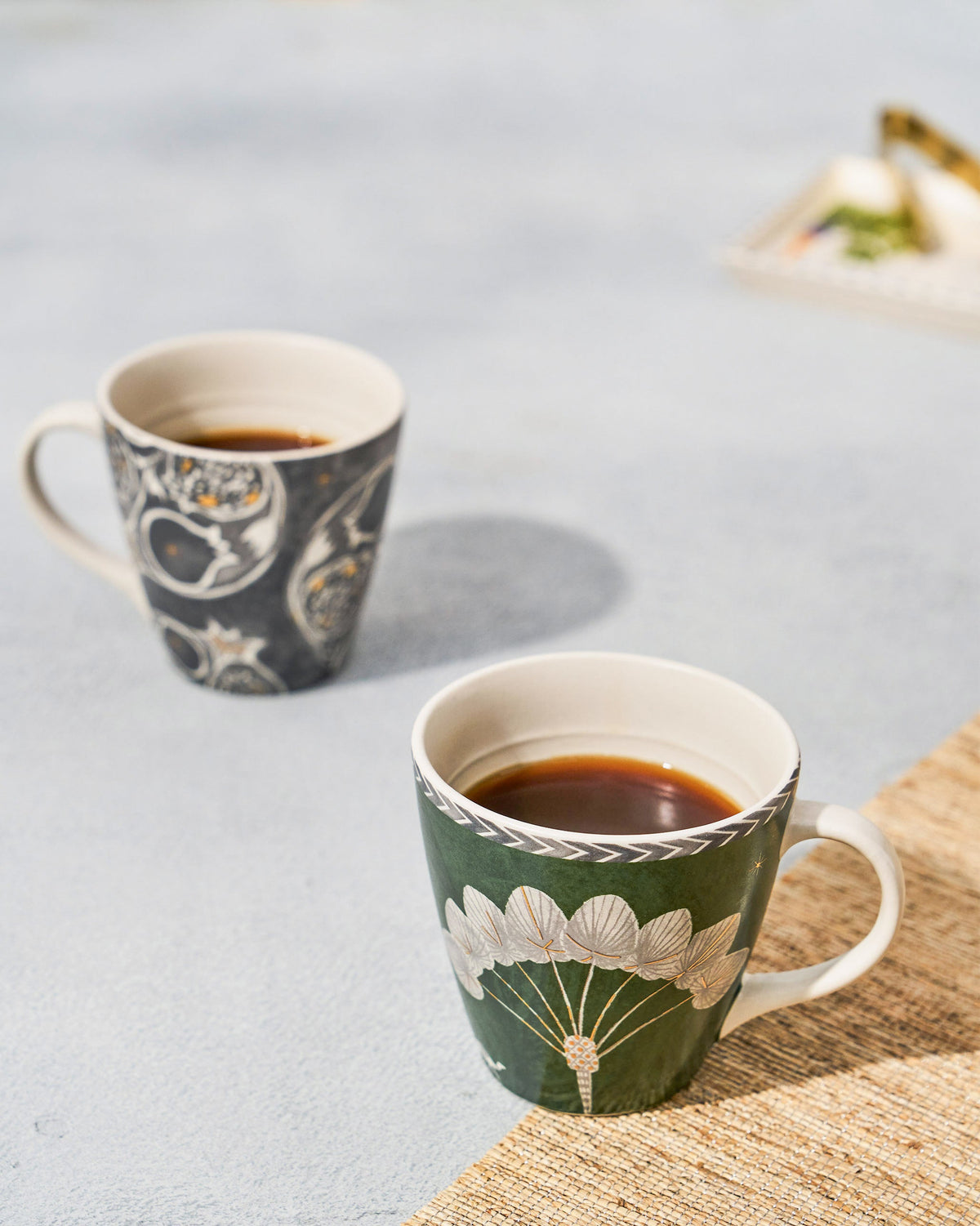 Anar Palm Conical Mugs filled with a dark drink on a grey surface.
