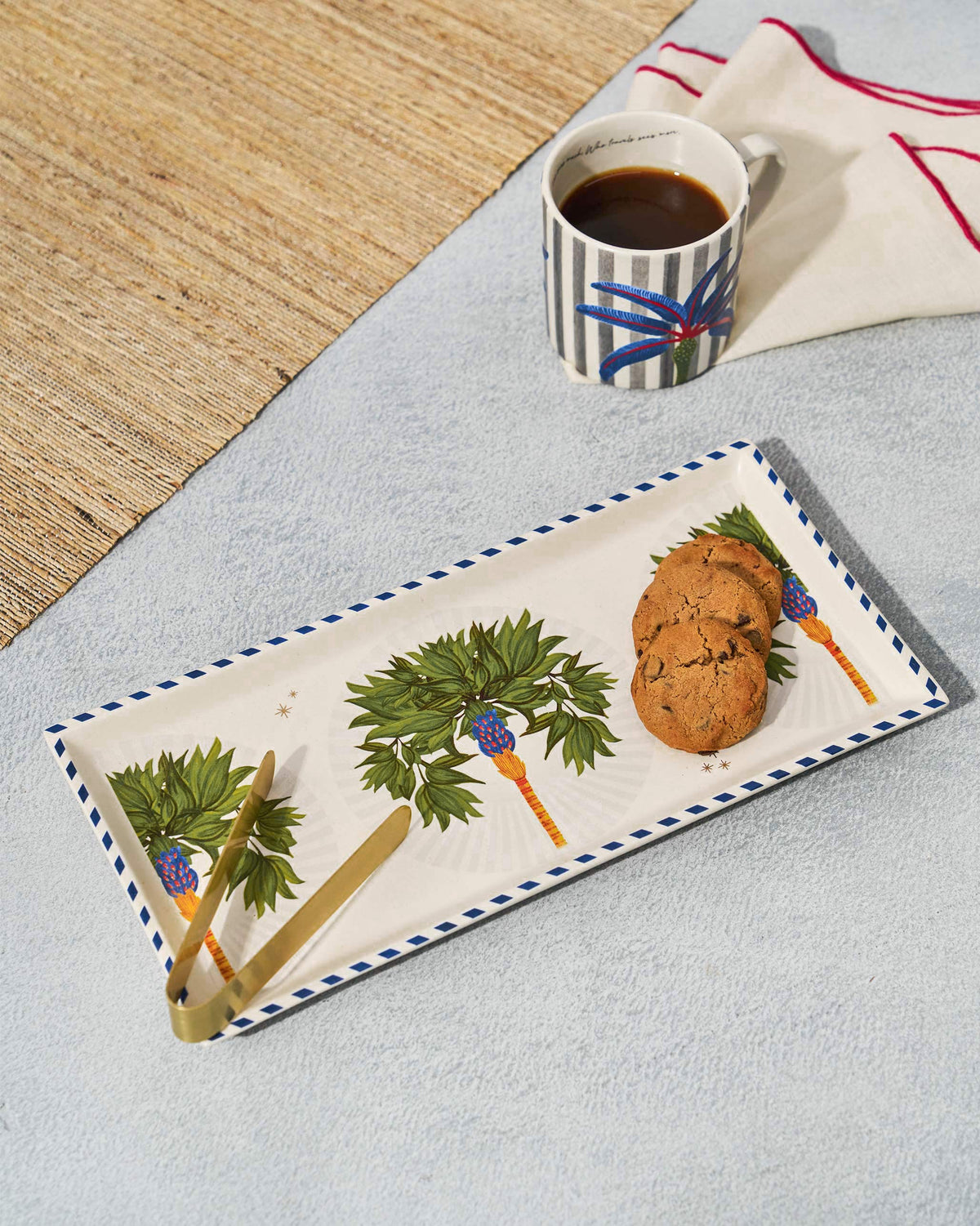 Desert Trail Cookie Tray with Tong, showing palm motifs and a gold tong at the left edge.