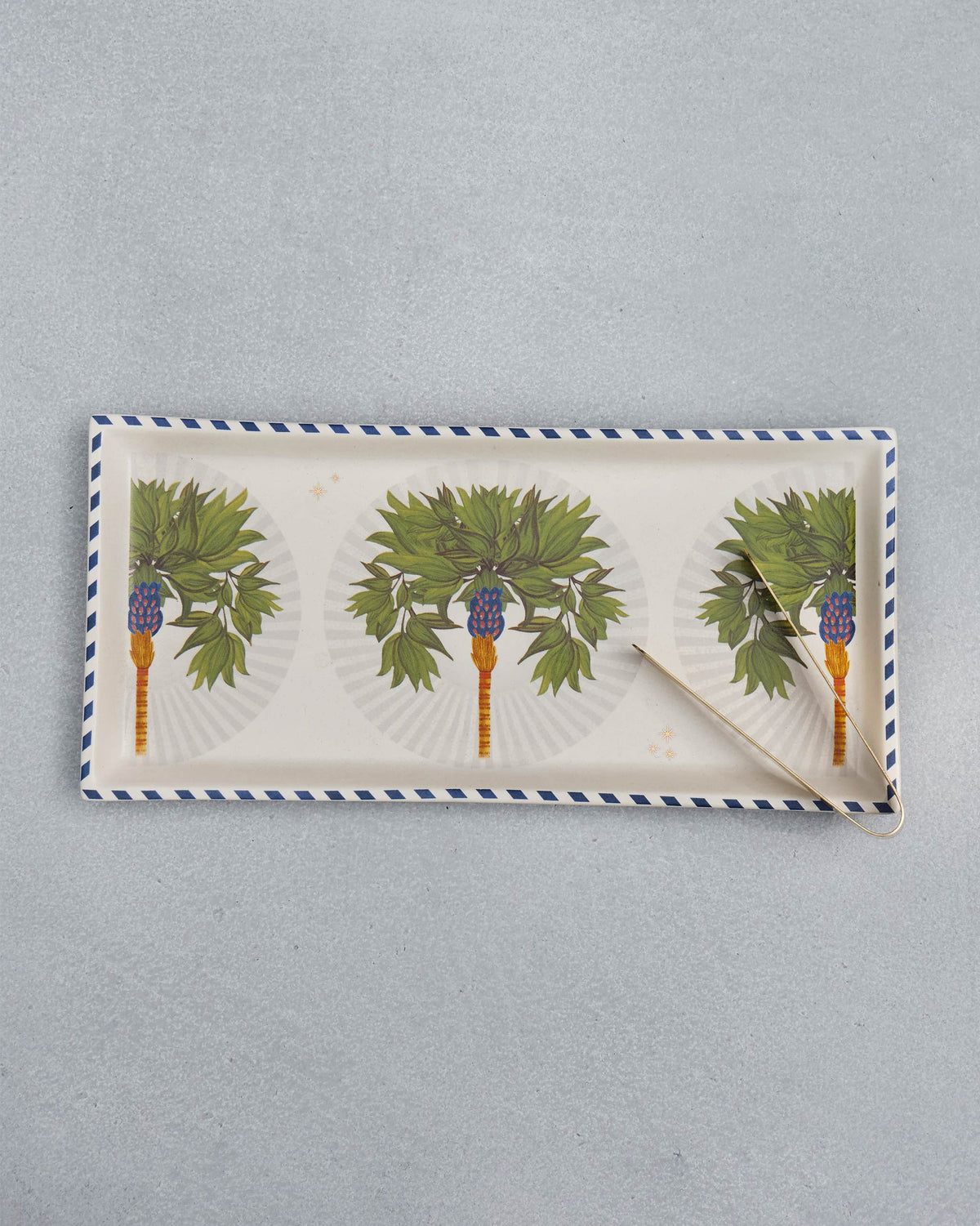 Overhead view of the Desert Trail Cookie Tray with Tong and its row of palm motifs.