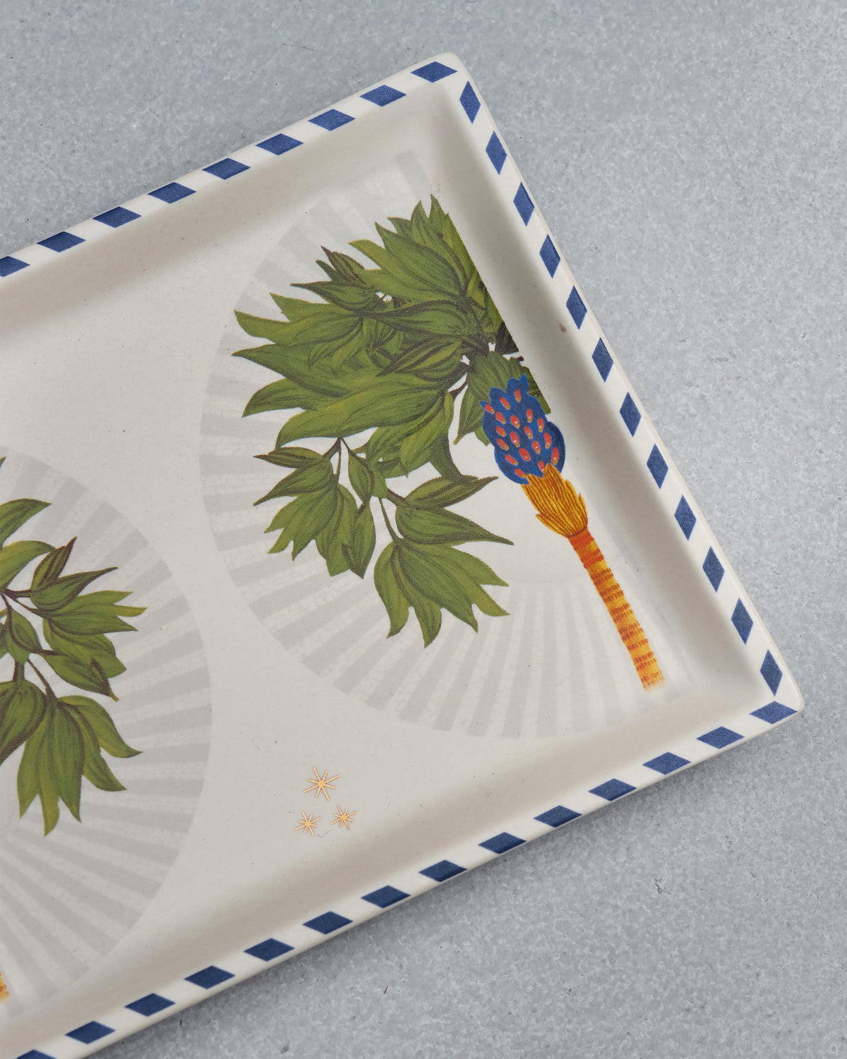 Close-up of the Desert Trail Cookie Tray showing a palm motif with a blue scalloped border.