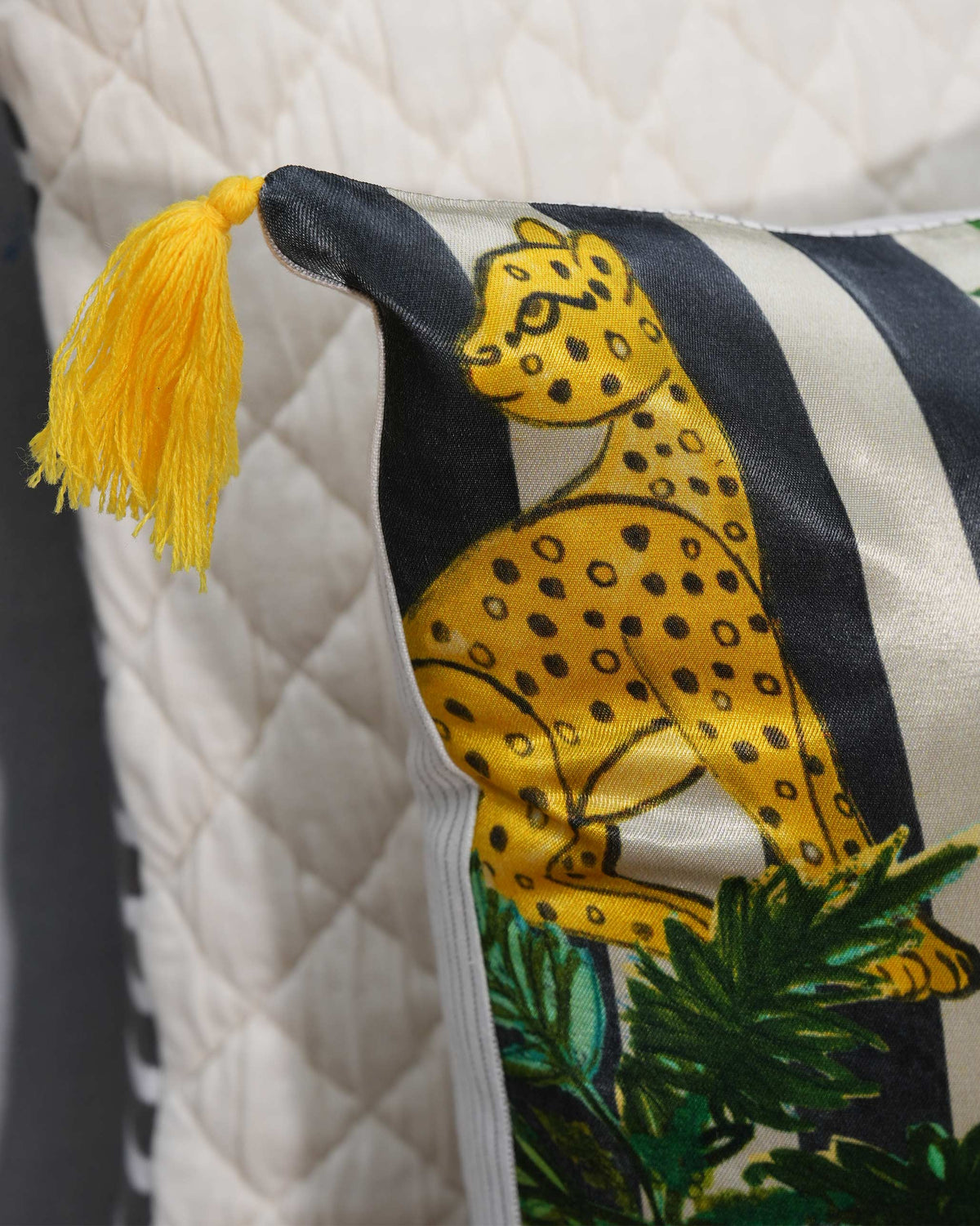 Close-up of Leopard Grove Cushion Cover showing a leopard on black and cream stripes.