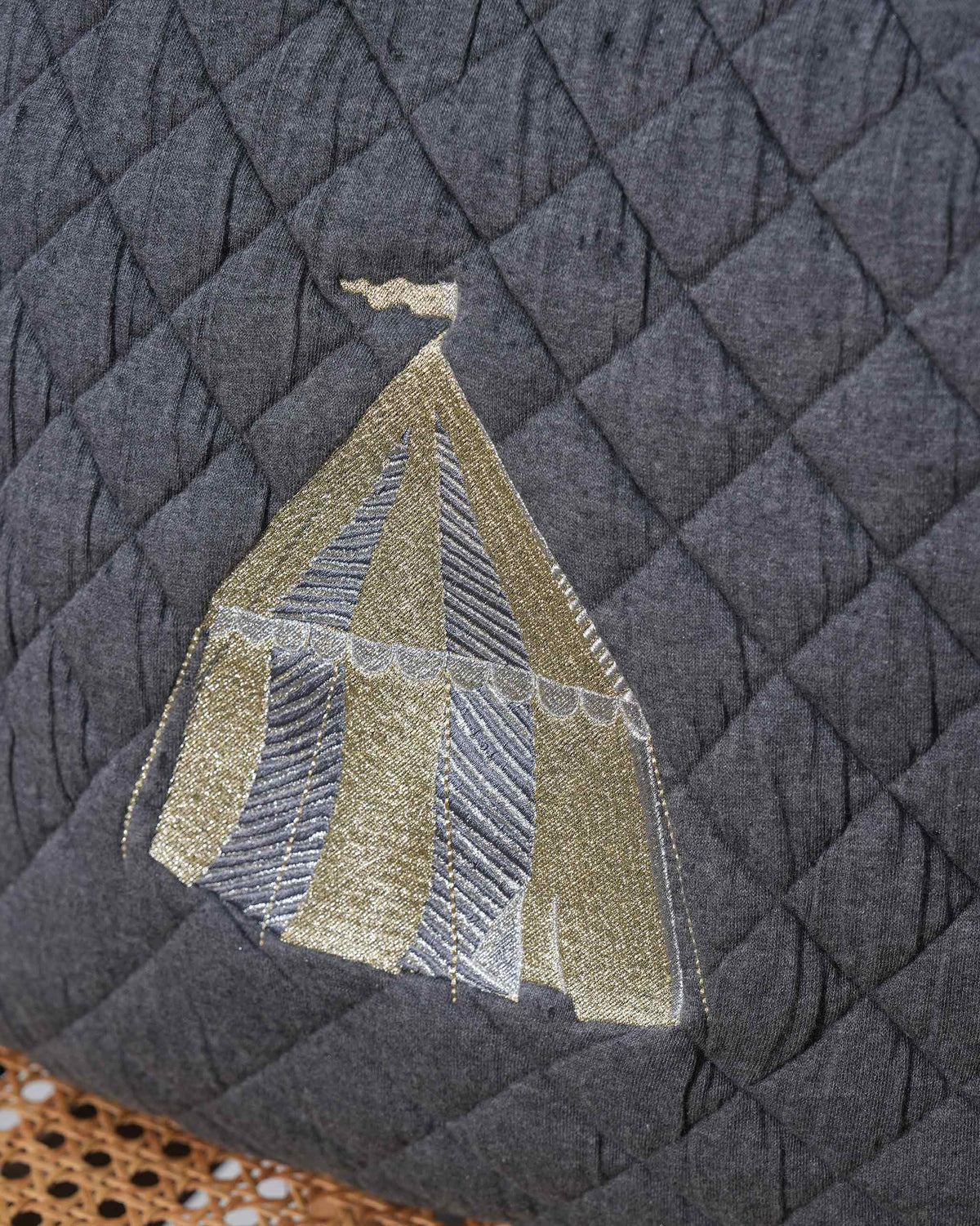 Close-up of Sahara Tent Cushion Cover showing gold and silver tent embroidery.