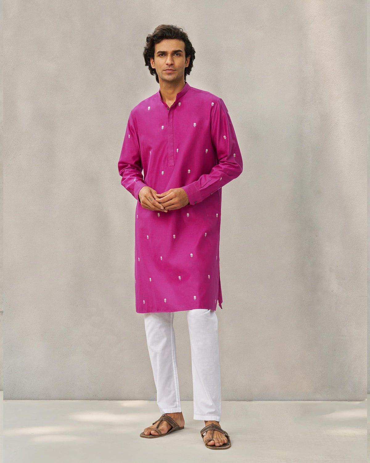 Person standing with hands together in a magenta neckband kurta.