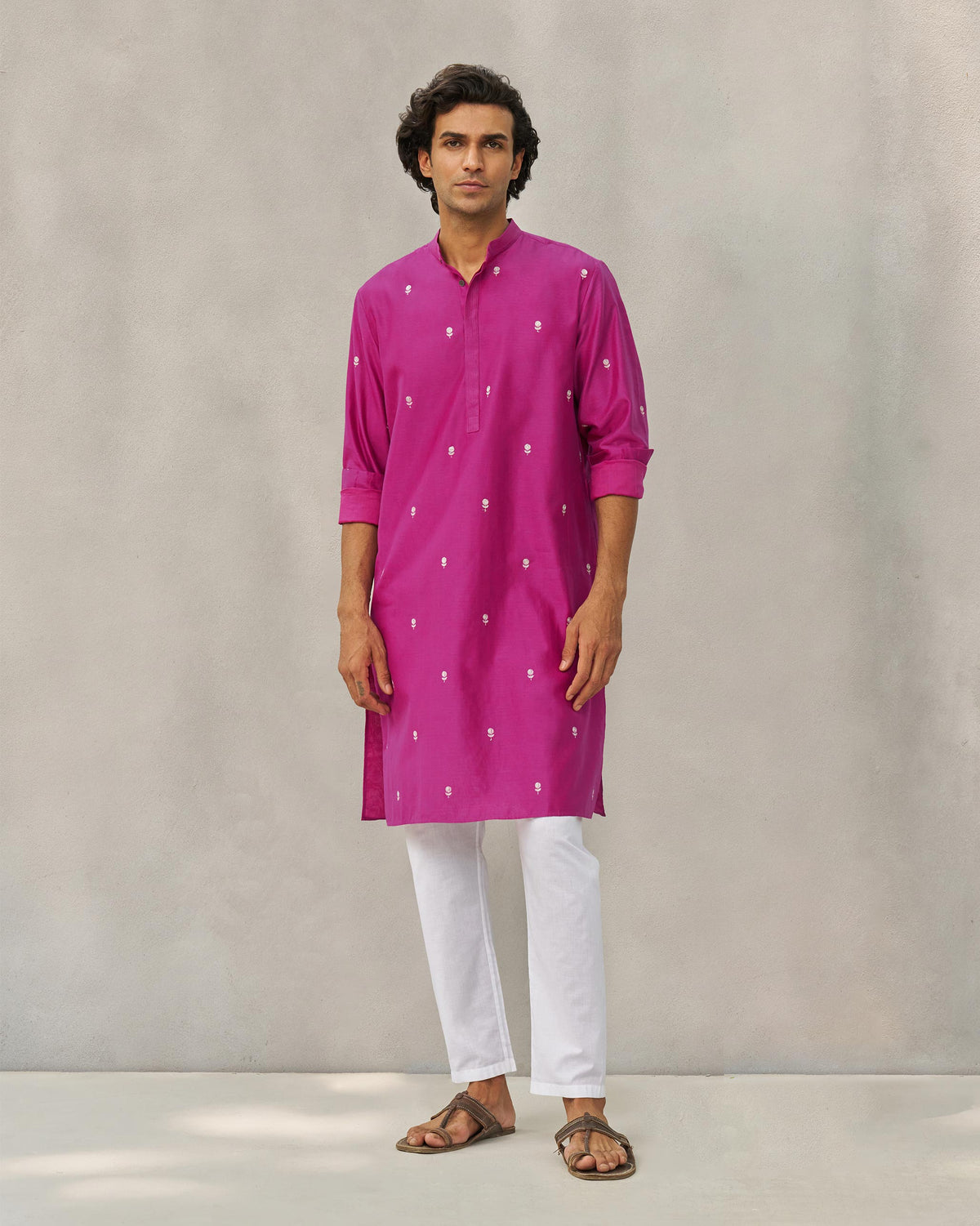 Person in a magenta neckband kurta, standing with arms relaxed at the sides.
