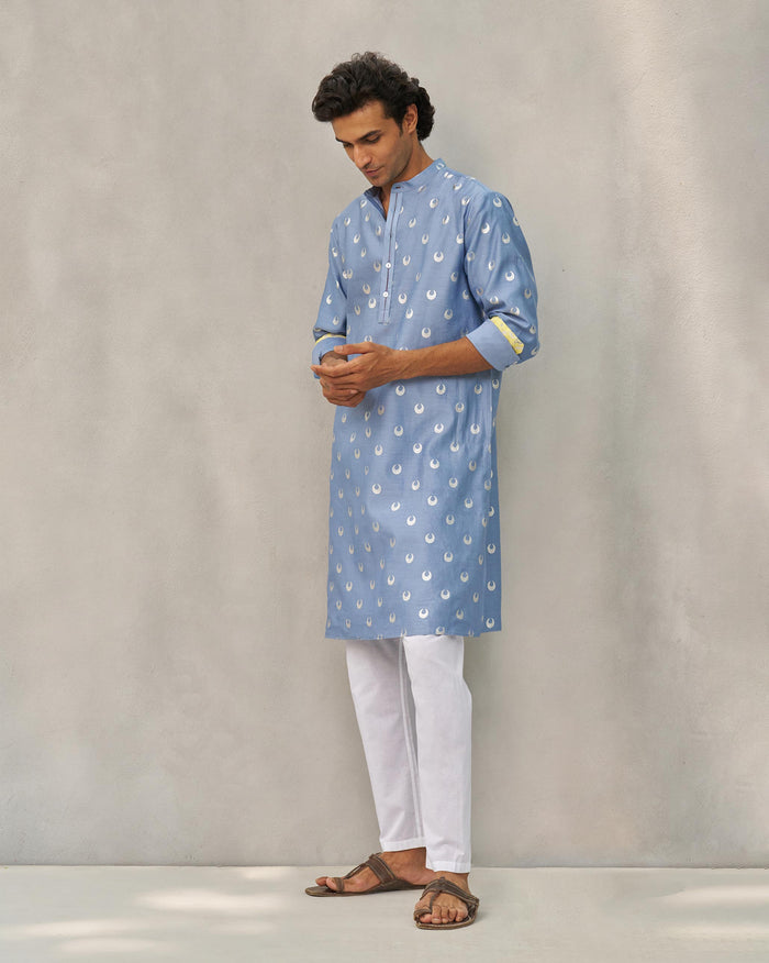 Person wearing a blue and silver astral kurta with moon print.