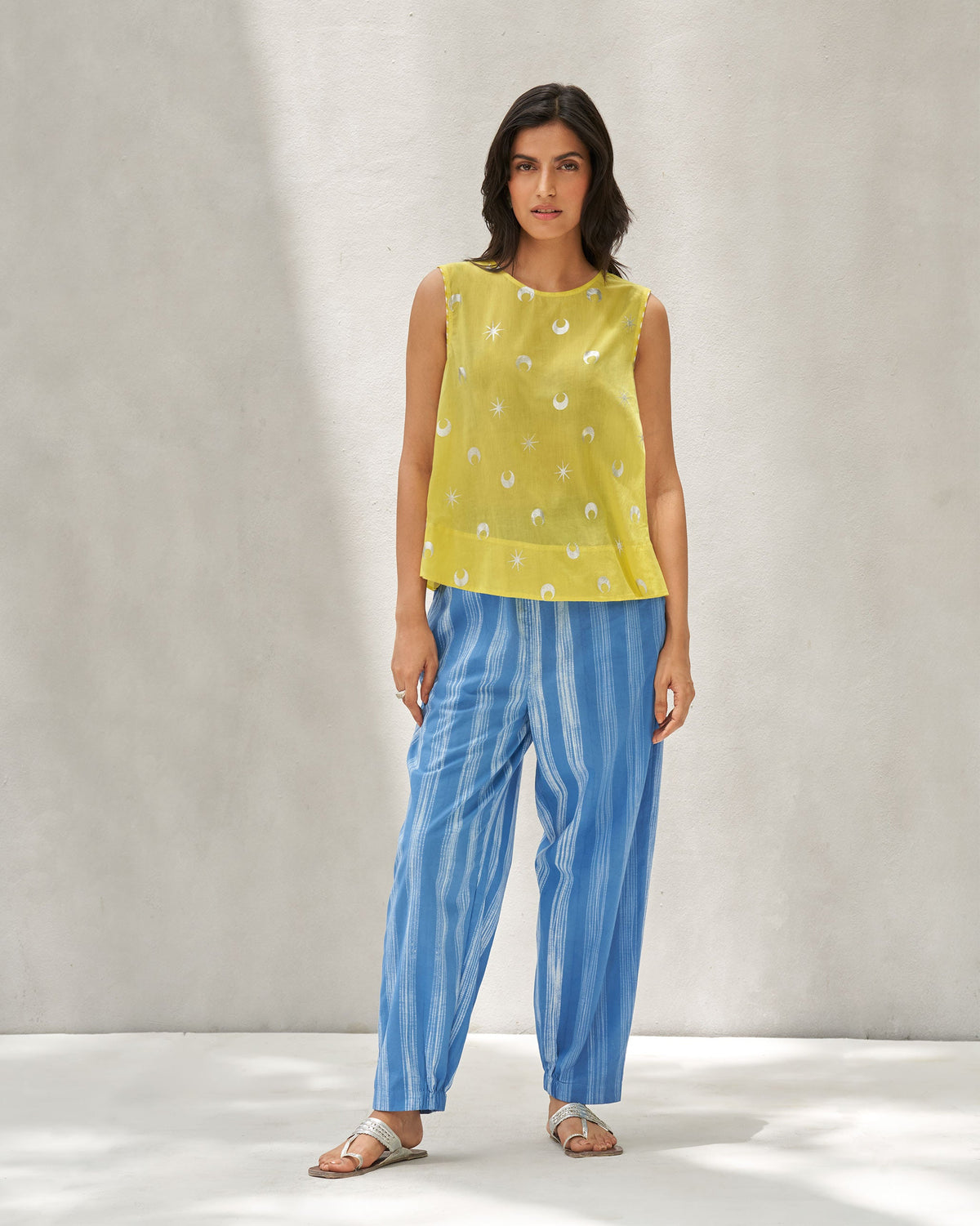 Full-length view of a yellow Demi Moon Ruffle Top worn by a person.