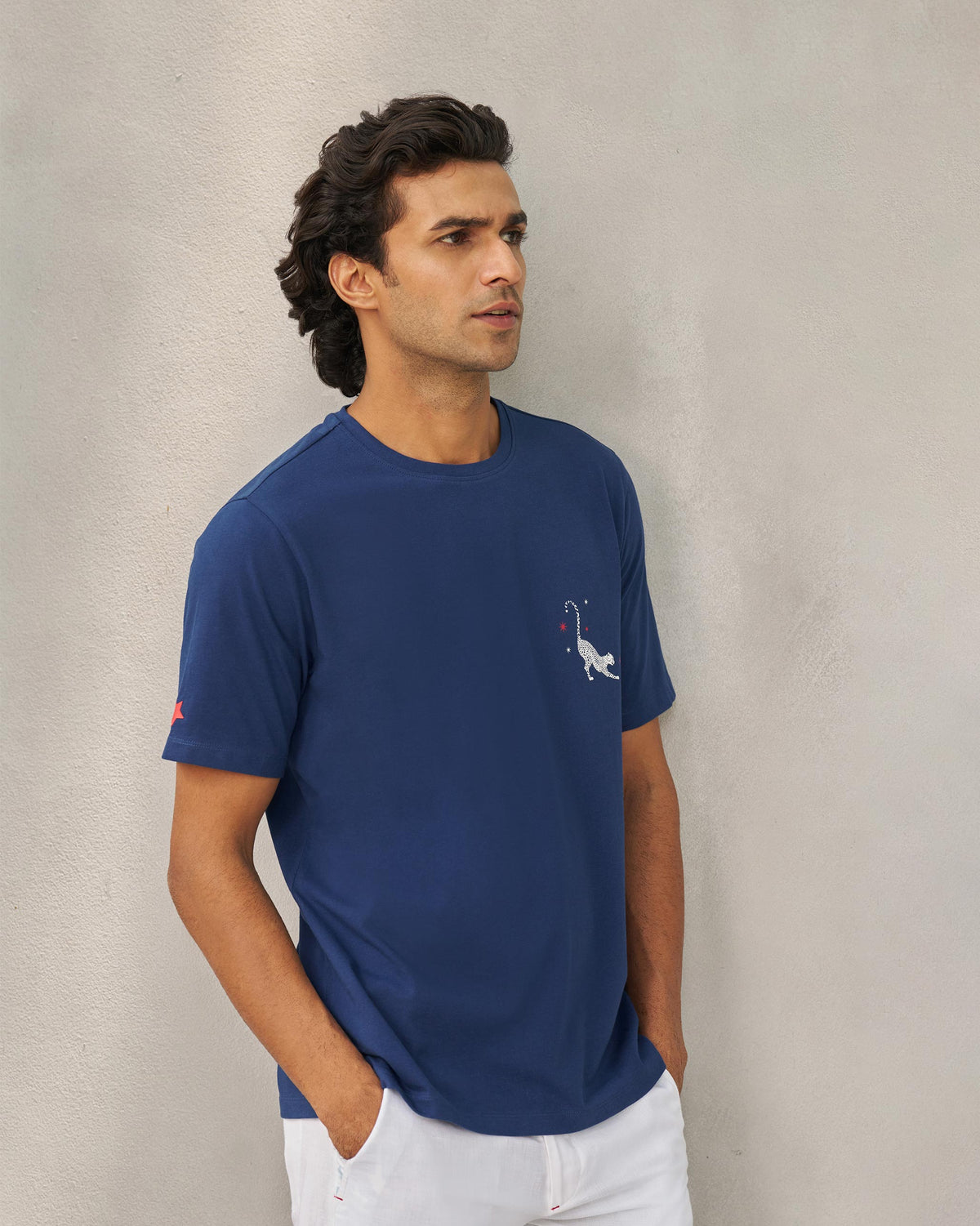 Three-quarter view of a navy Party Cheetah T-shirt with a cheetah motif on the chest.