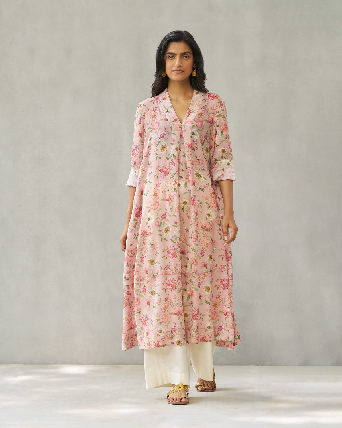 Person wearing a pink Banko V-neck kurta with a small floral print.