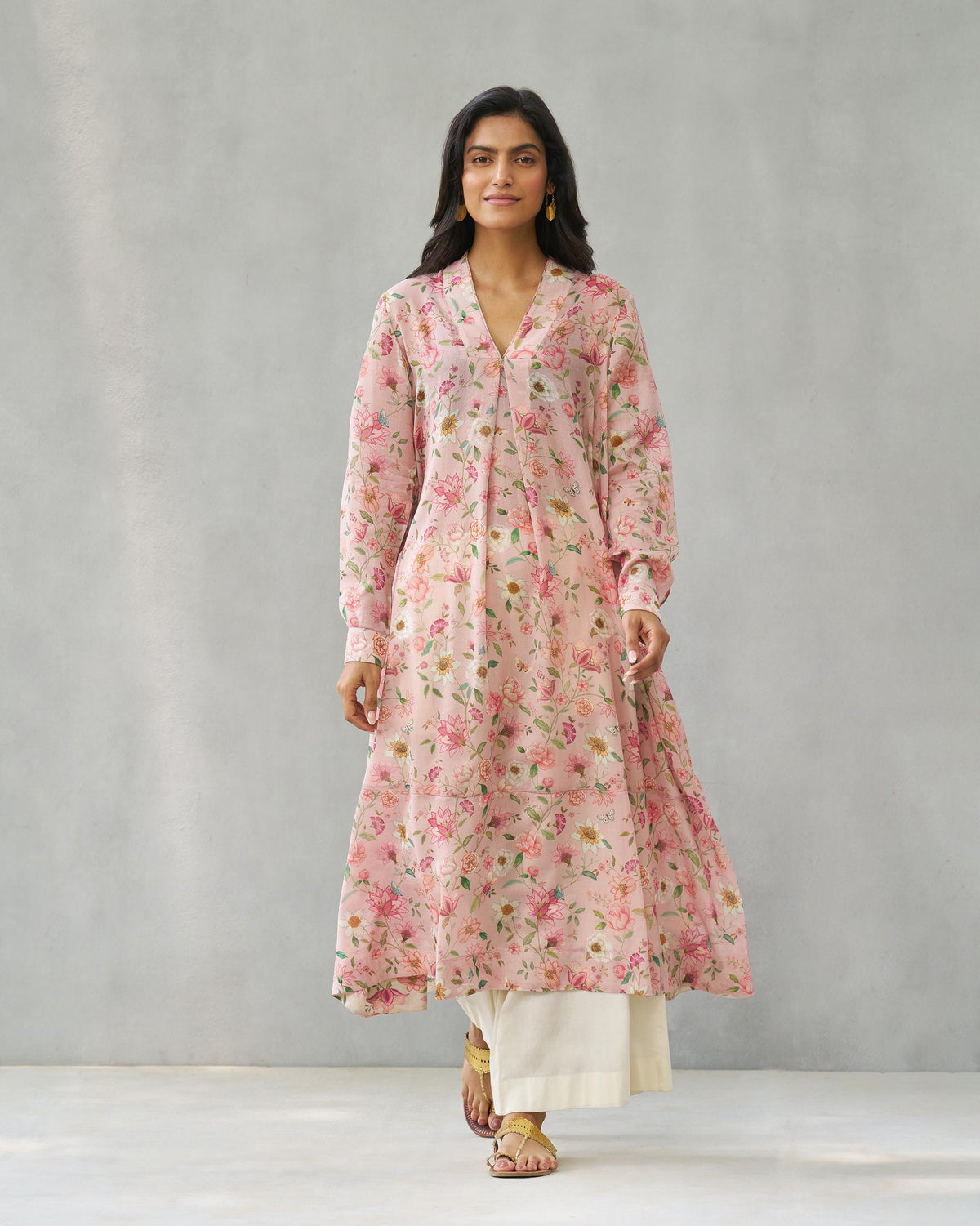 Person wearing the pink Banko V-neck kurta with a tie at the neckline.