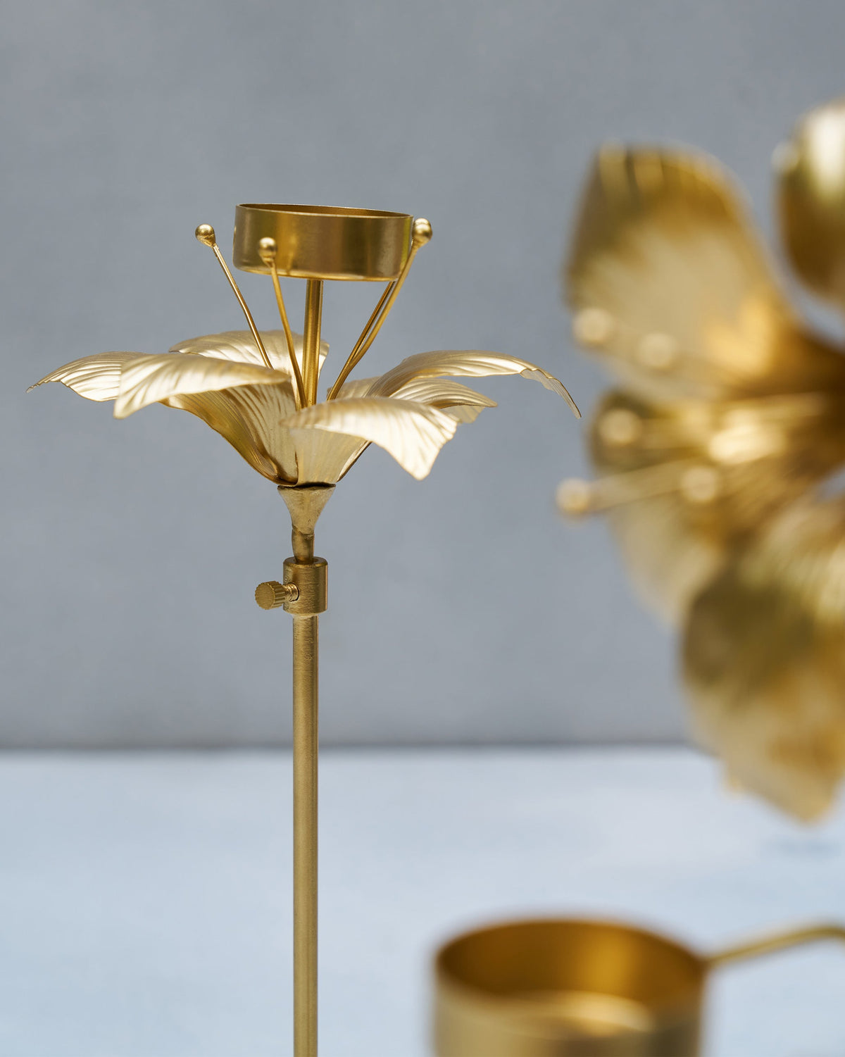 Gold Amaryllis Bloom Tealight Holder with petal arms below the cup.