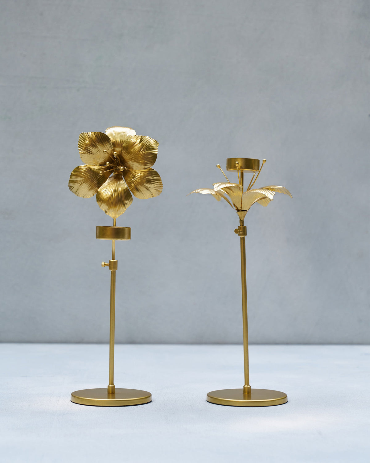 Pair of Amaryllis Bloom Tealight Holders standing side by side at different heights.