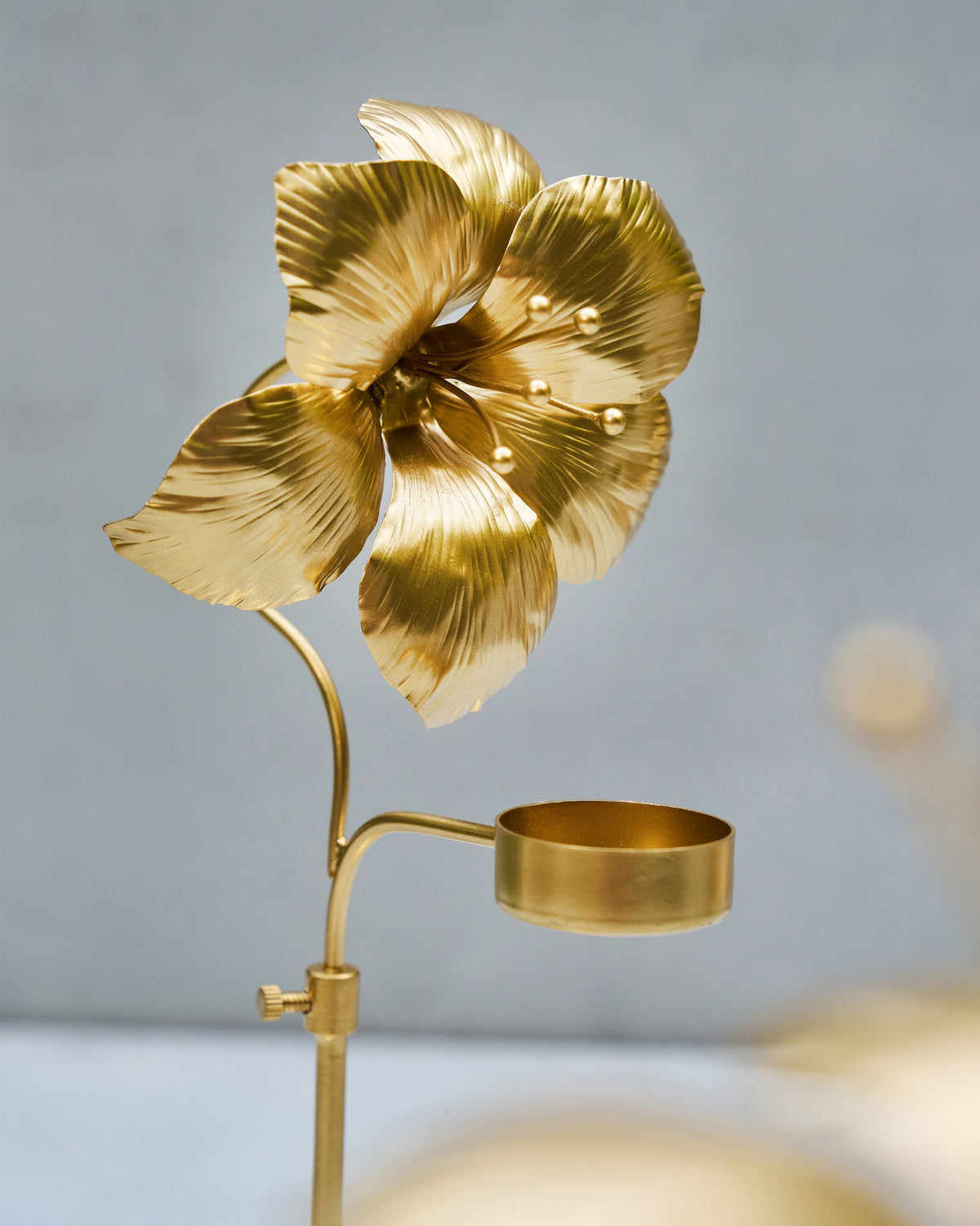 Close-up of the Amaryllis Bloom Tealight Holder's bloom head and angled cup.