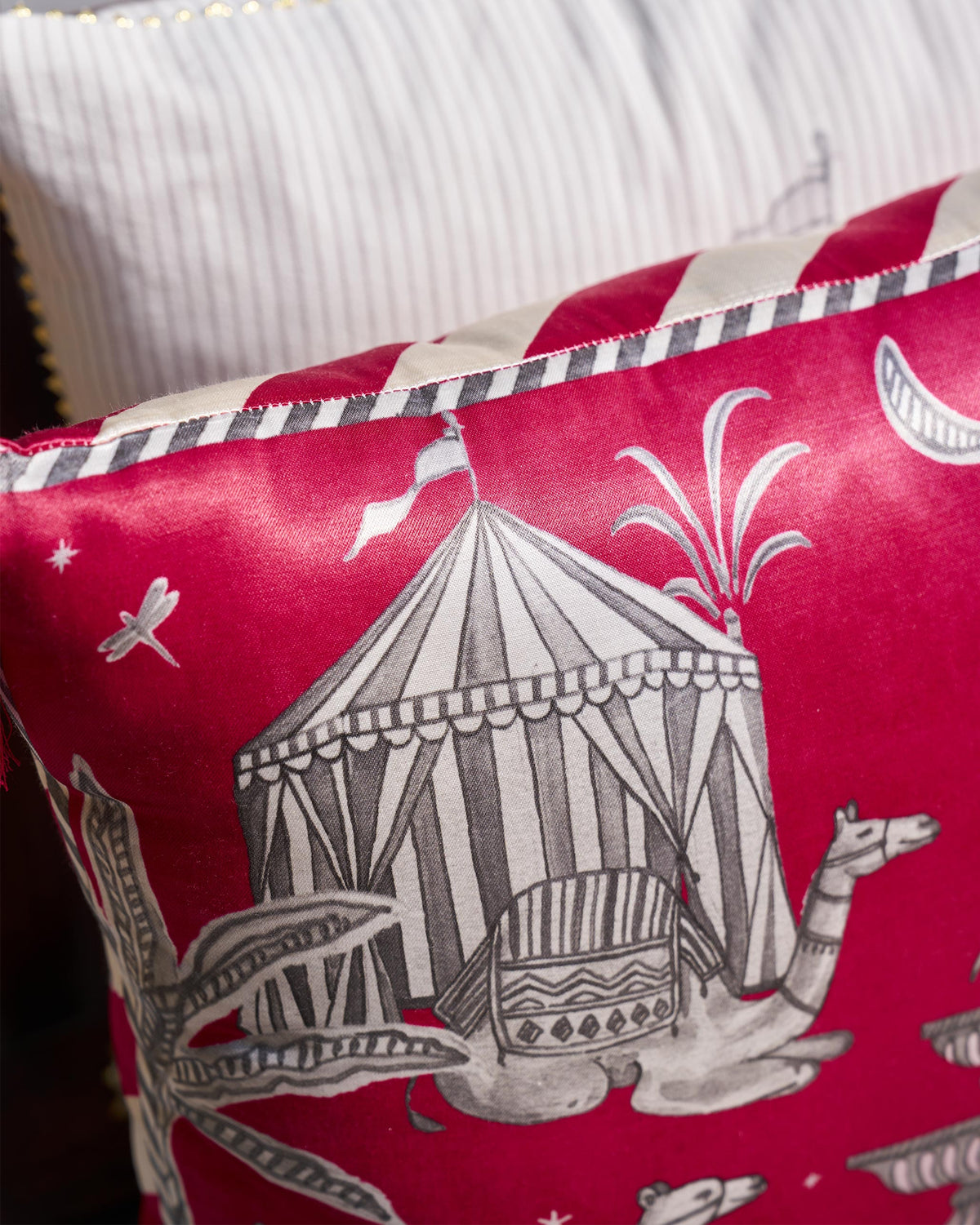 Close-up of the Tinghir cushion cover showing a striped tent and palm motifs.