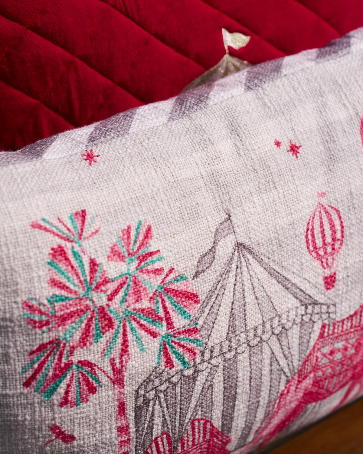Close-up of the Tinghir lumbar cushion cover showing a striped tent and a hot-air balloon.