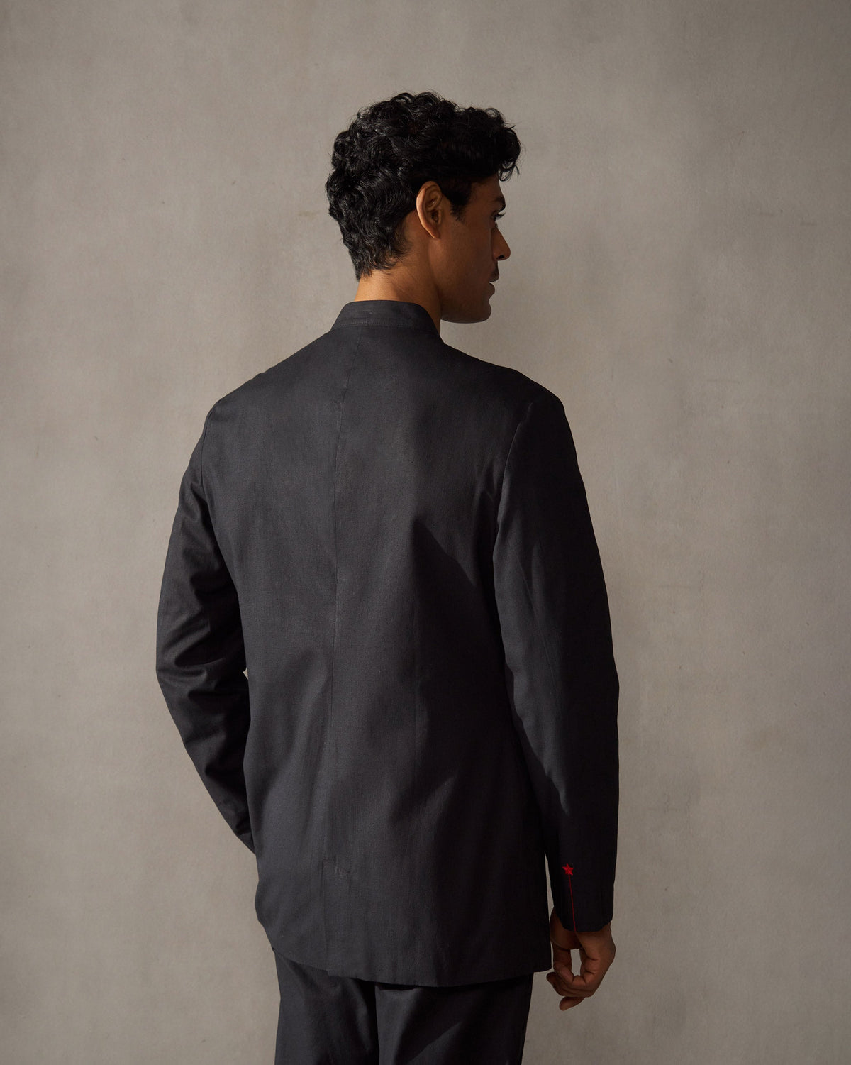 Back of a black Short Bandhgala Jacket worn by a person.