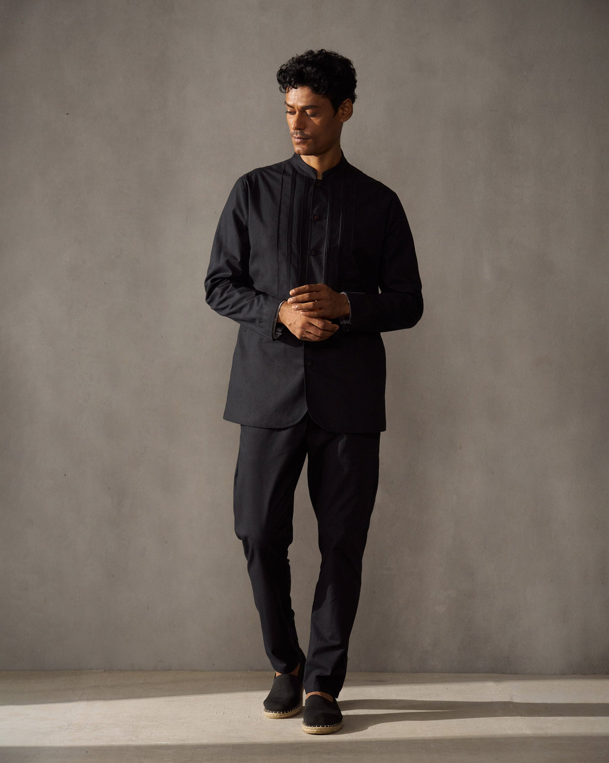 Person wearing a black Short Bandhgala Jacket, shown full length.