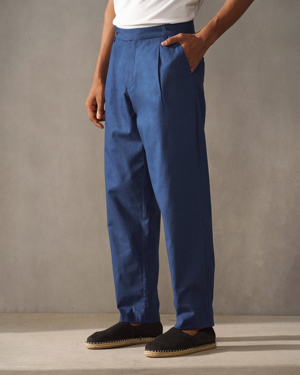 Side view of navy Coast Pants with a front pleat.