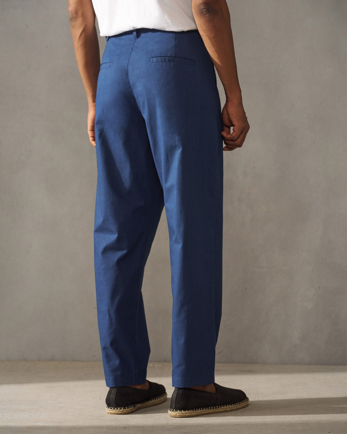 Back of navy Coast Pants with two welt back pockets.