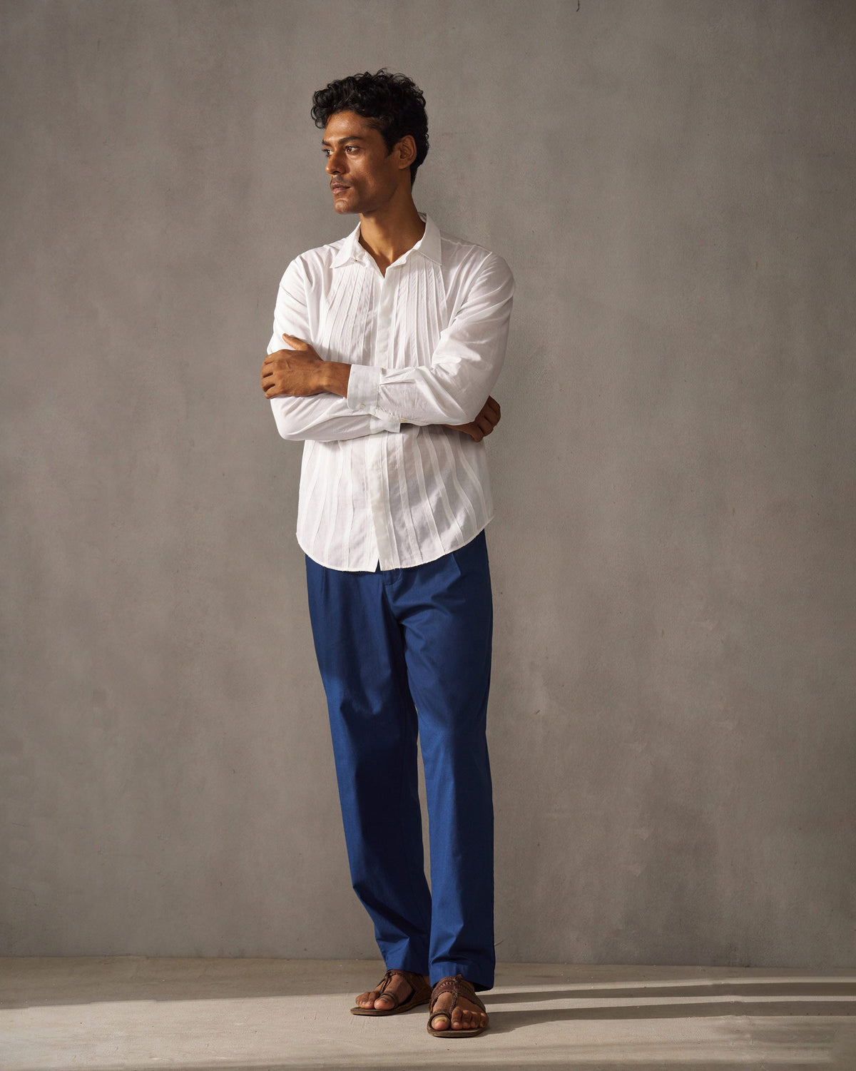 Full-length view of navy Coast Pants worn by a person.