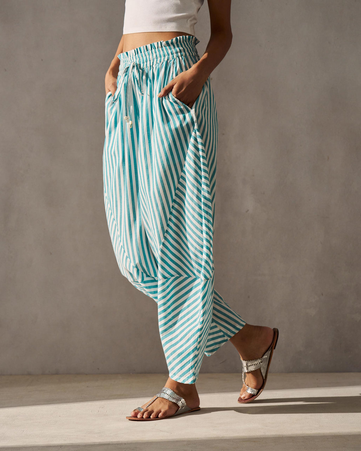 Side view of the Breeze Pants with a tapered leg and side pockets, worn by a person.